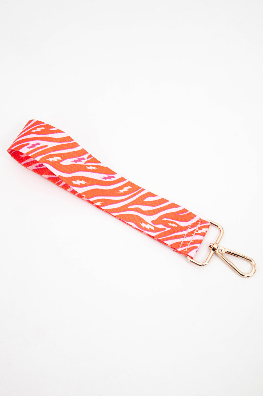 pink and orange zebra and lightning bolt pattern detachable wrist strap for a small clutch bag