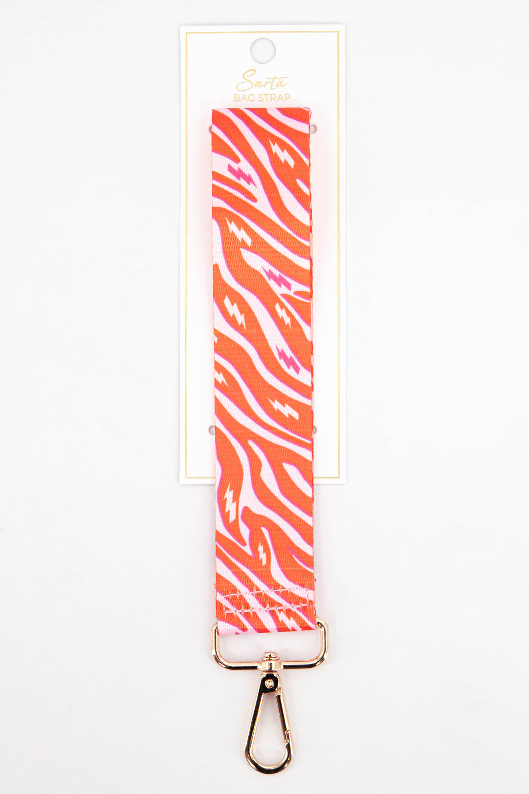 pink and orange zebra and lightning bolt pattern wrist strap with gold clip on hardware