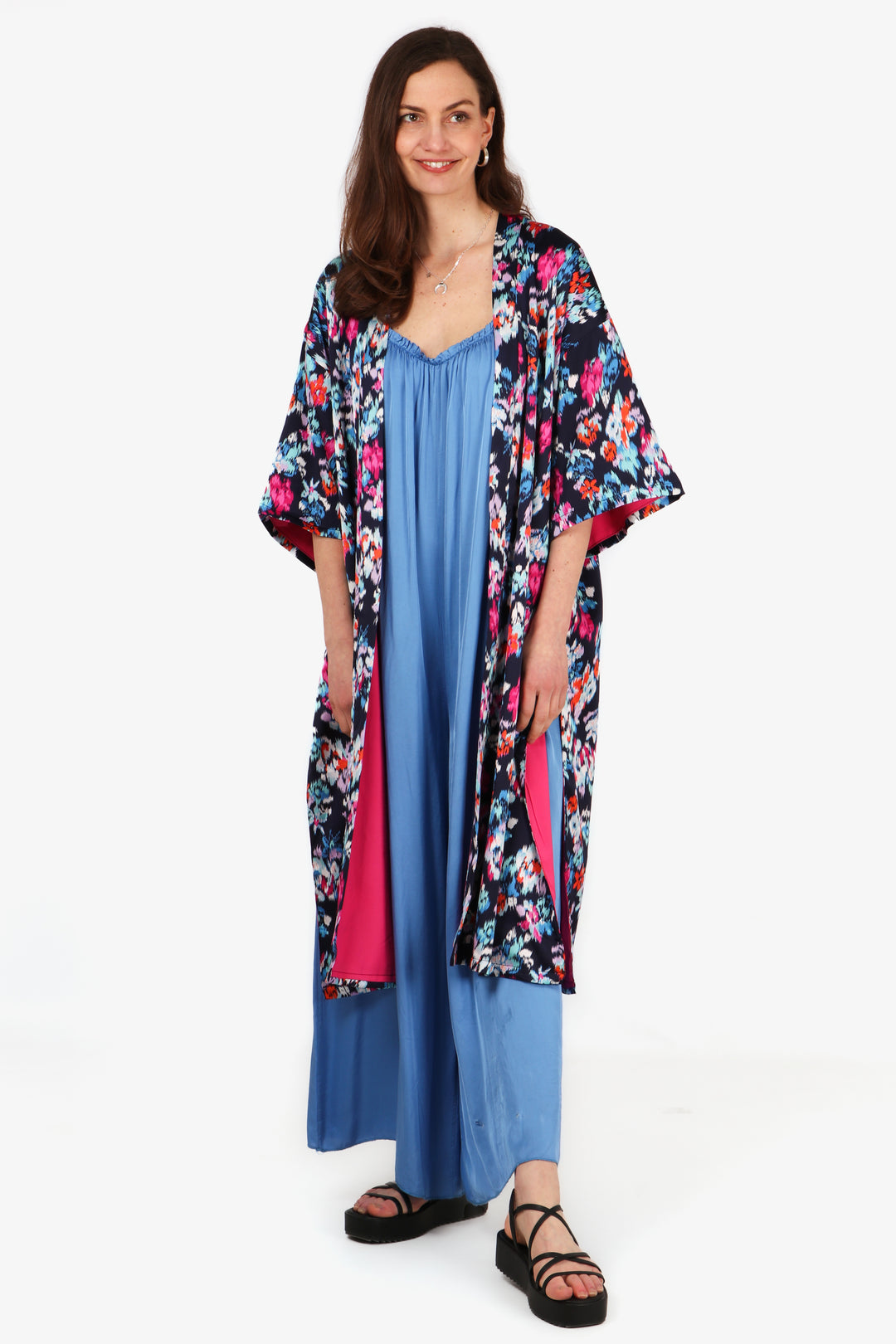 model wearing a mutlicolorued floral print kimono jacket with pink lining, the floral print is navy blue, white, red and pink 1