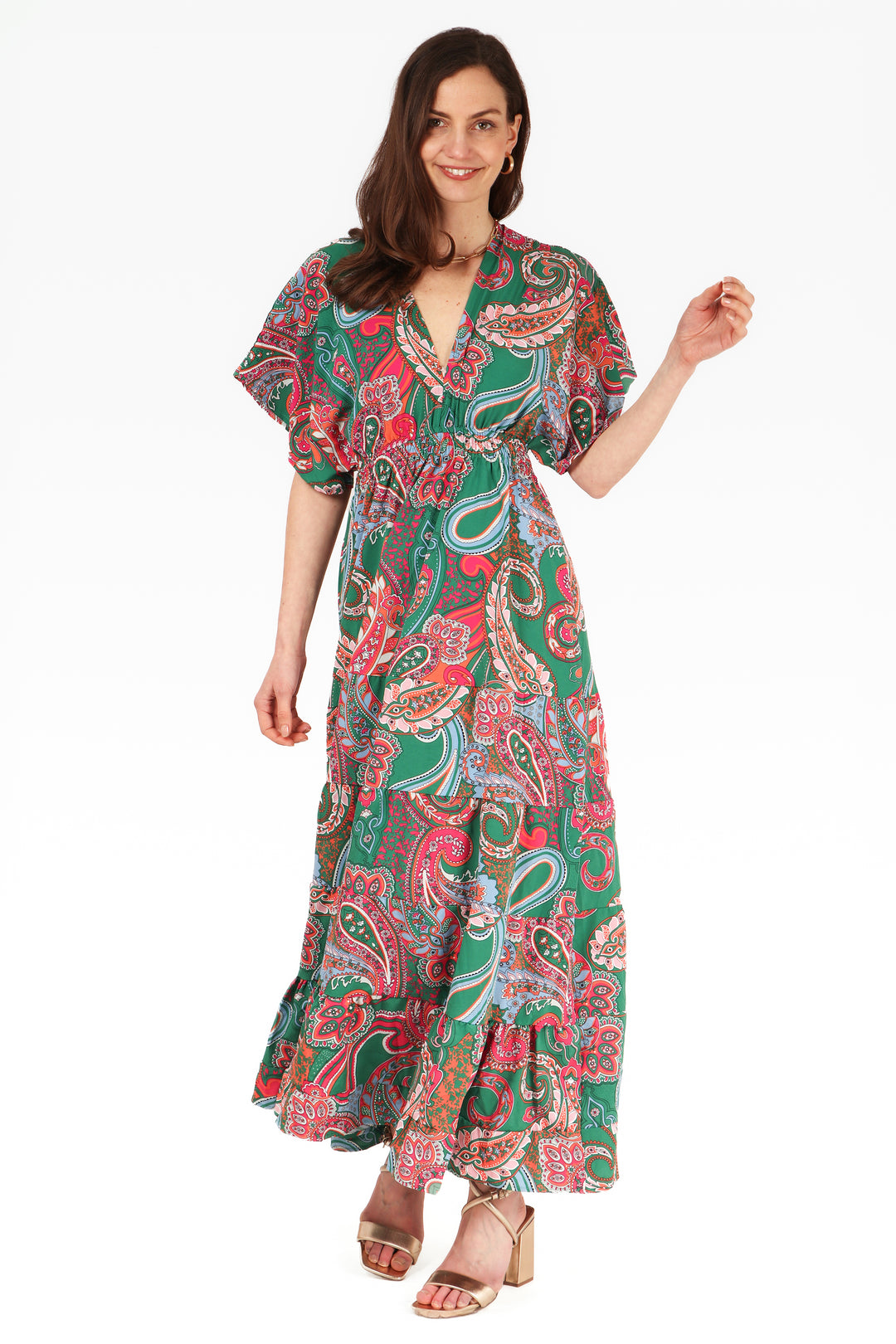 model wearing a maxi length green and pink paisley patterns kaftan dress with elbow lenght sleeves and a plunging v neck