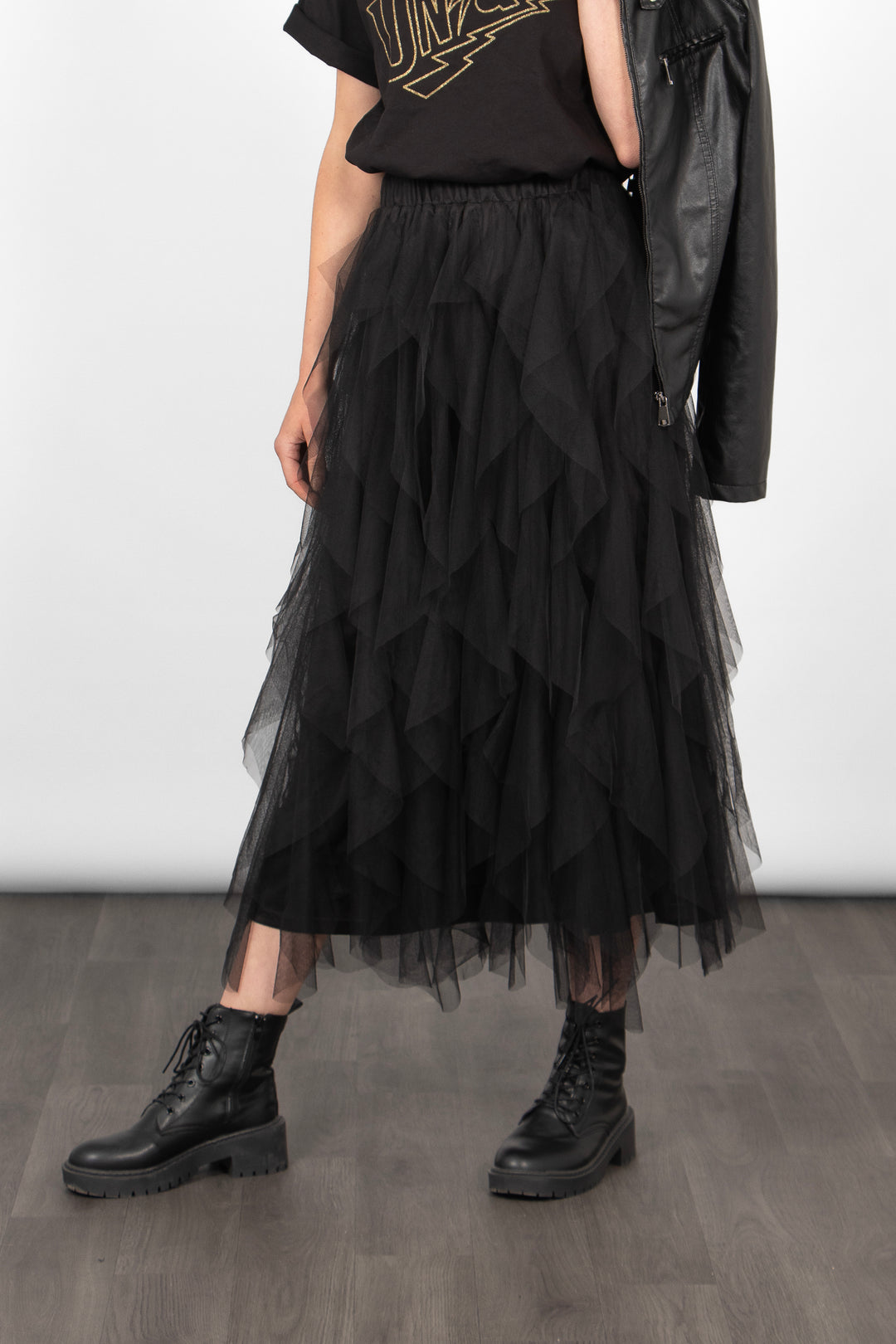 close up of model wearing a black gathered tulle midi skirt with an elasticated waistband