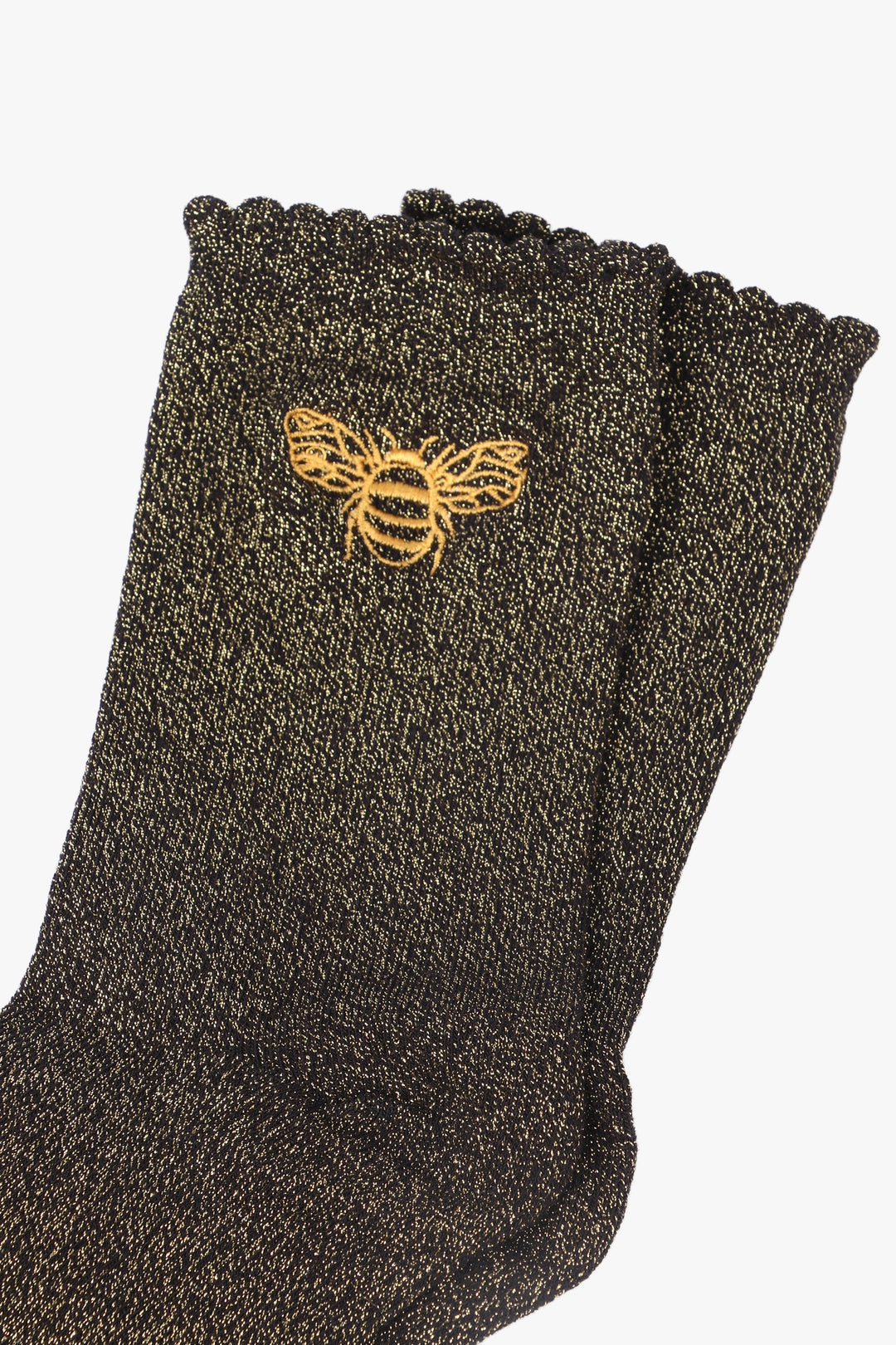 close up of the sparkly socks and embroidered gold bee