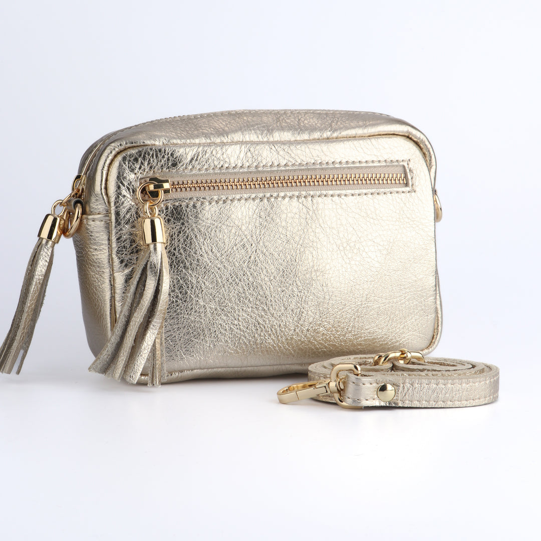 gold leather crossbody camera bag with a front zip pocket and matching detachable bag strap