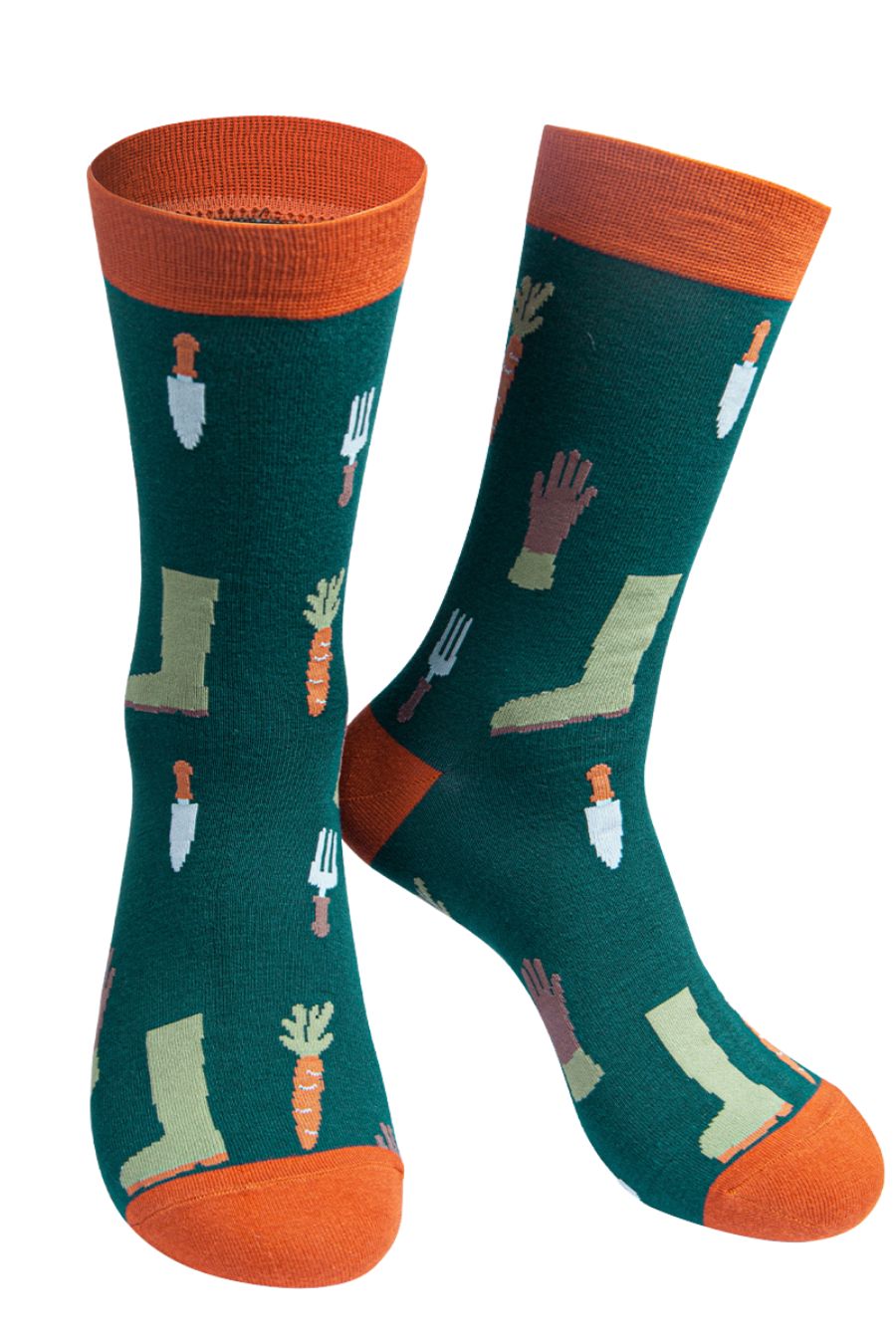 green socks with orange heel, toe and cuff with a pattern of gardening tools, gloves, boots and carrots