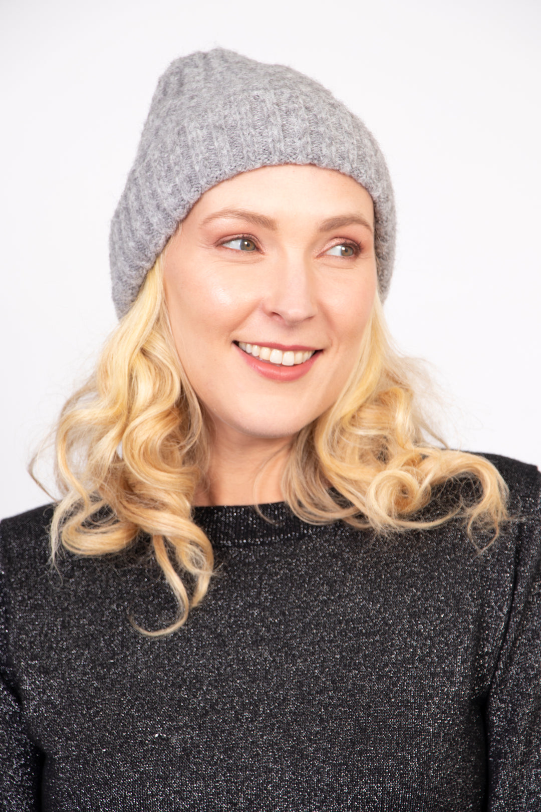 model wearing a grey cable knit winter beanie hat