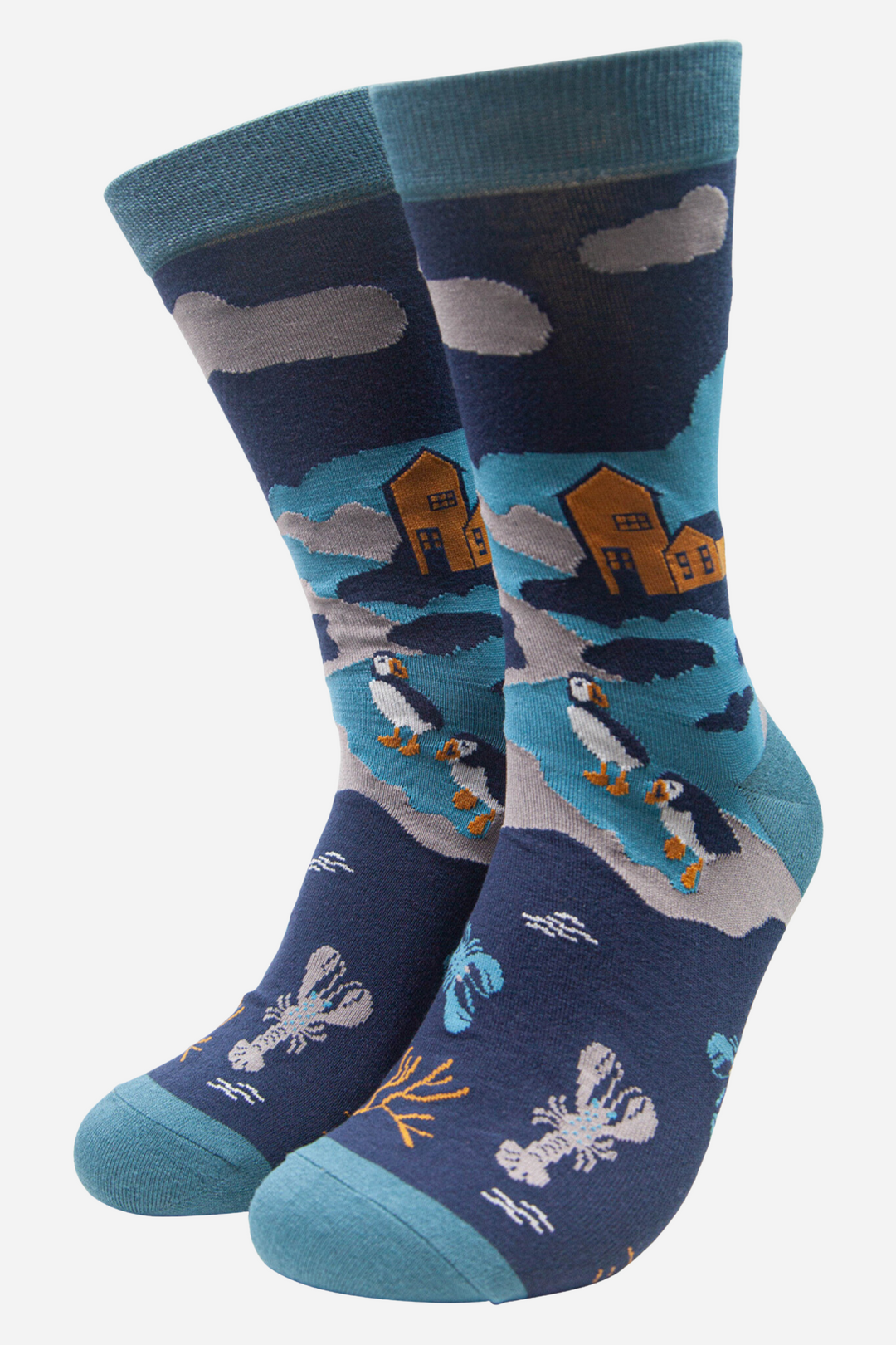 blue and teal socks with a pattern of puffins, lobsters and a coastal scenic view