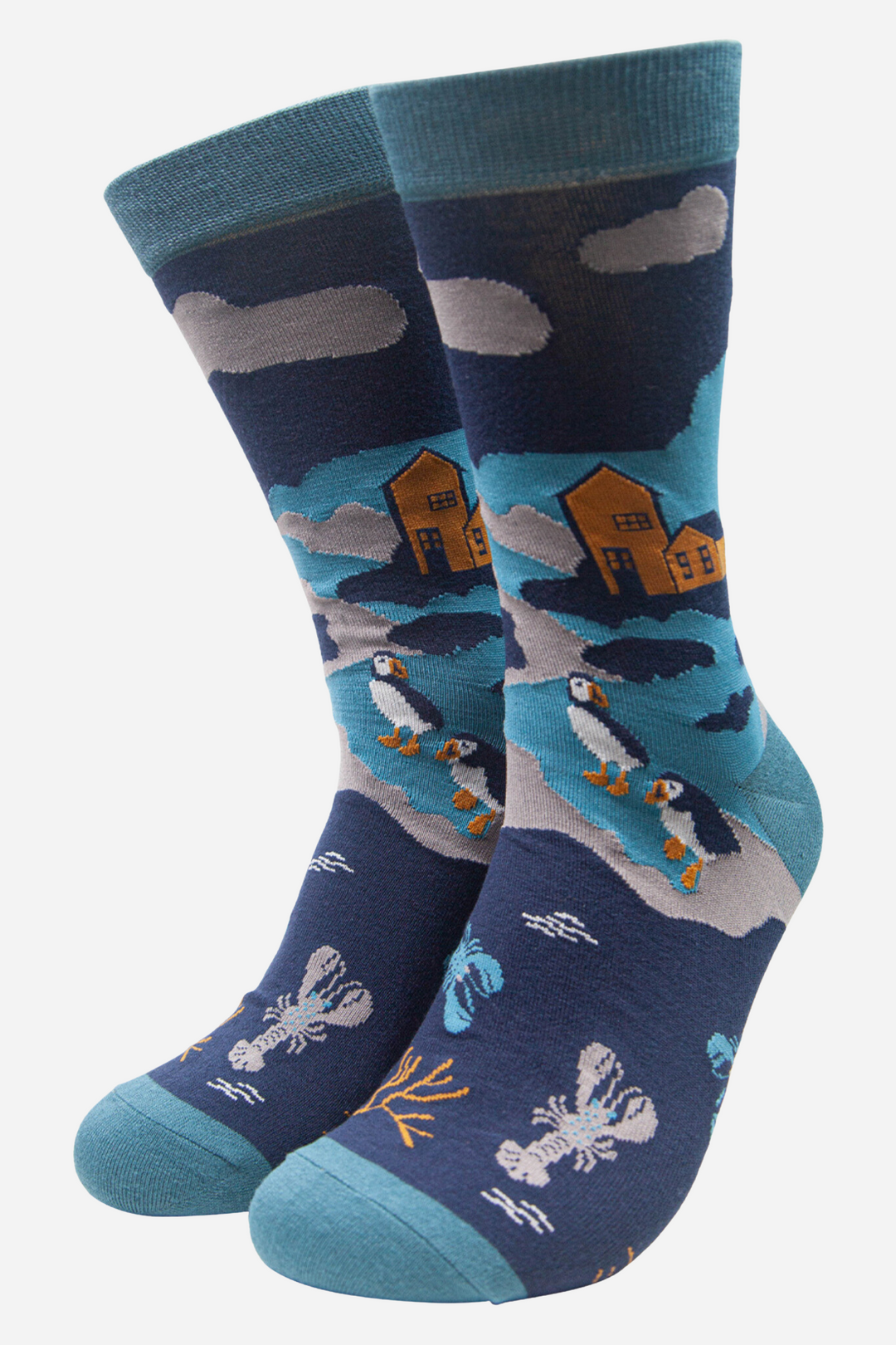 mens blue bamboo socks with puffins, lobsters and a seaside village in the background