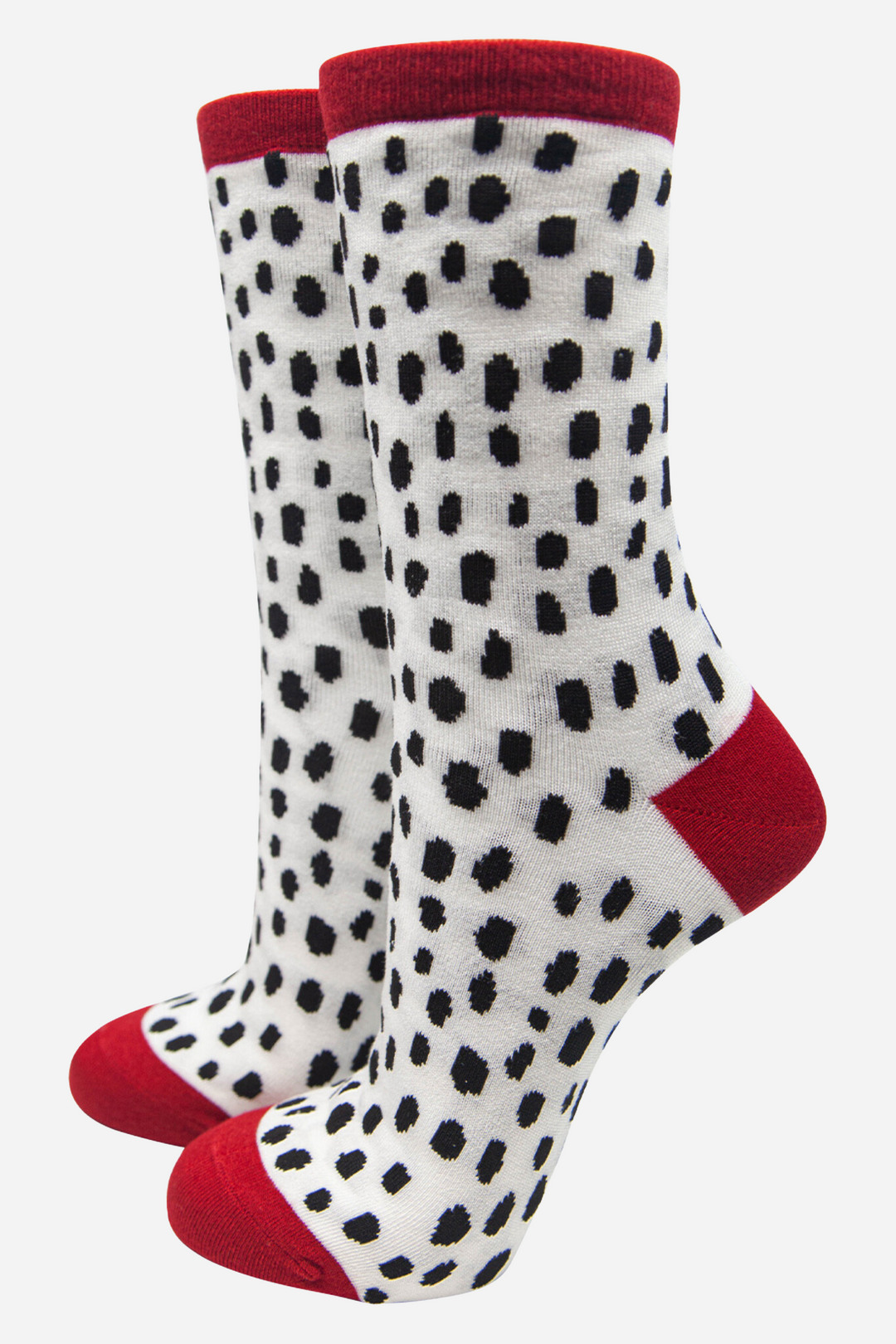 white socks with an all over black spotted dalmatian print pattern with red cuff, toe and heel