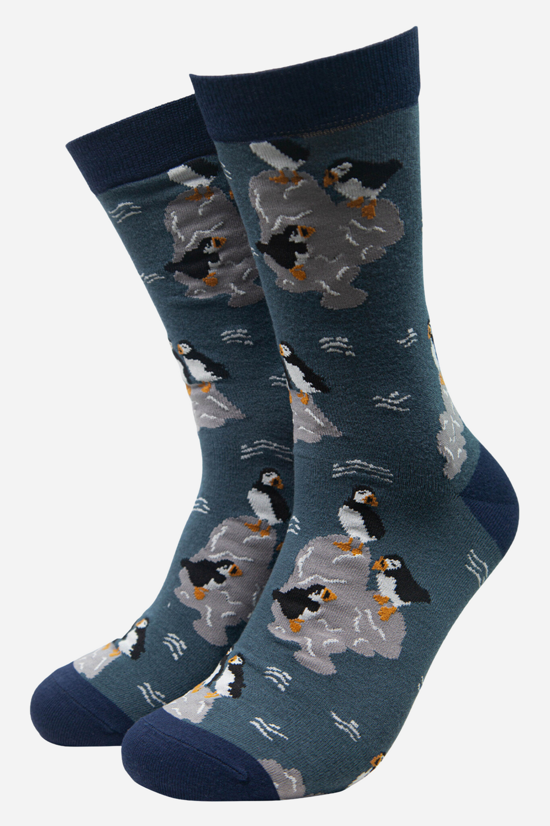 teal bamboo socks with a pattern of puffin seabirds sitting on rocks
