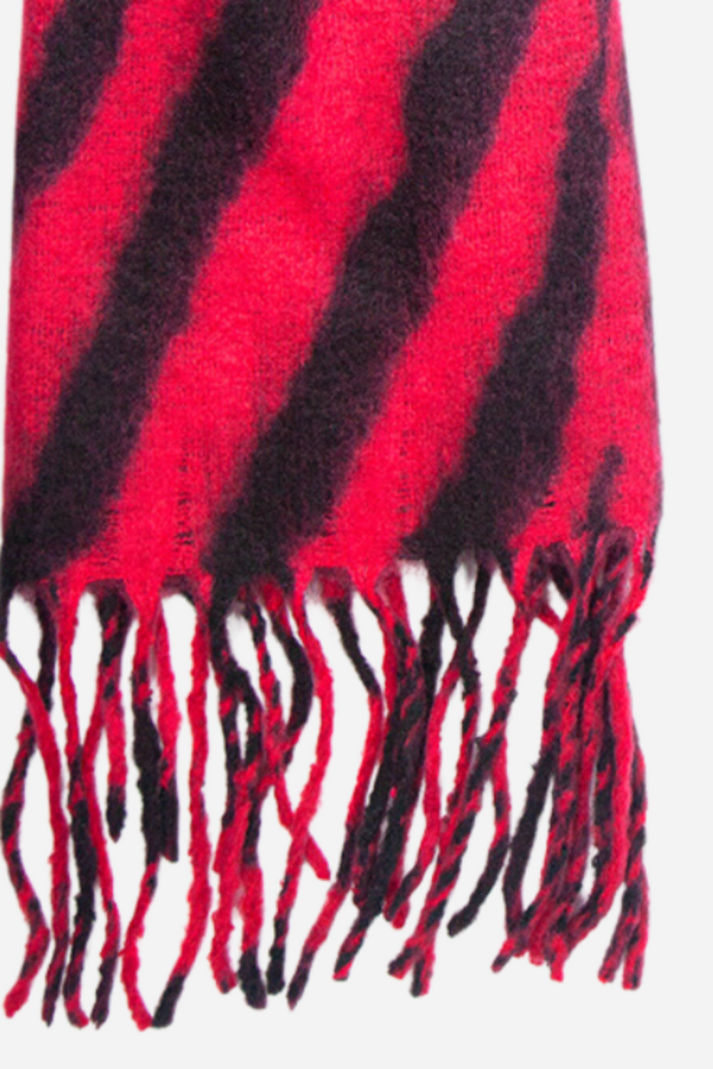 close up of the soft knitted warm material of the scarf and of the tassel trim