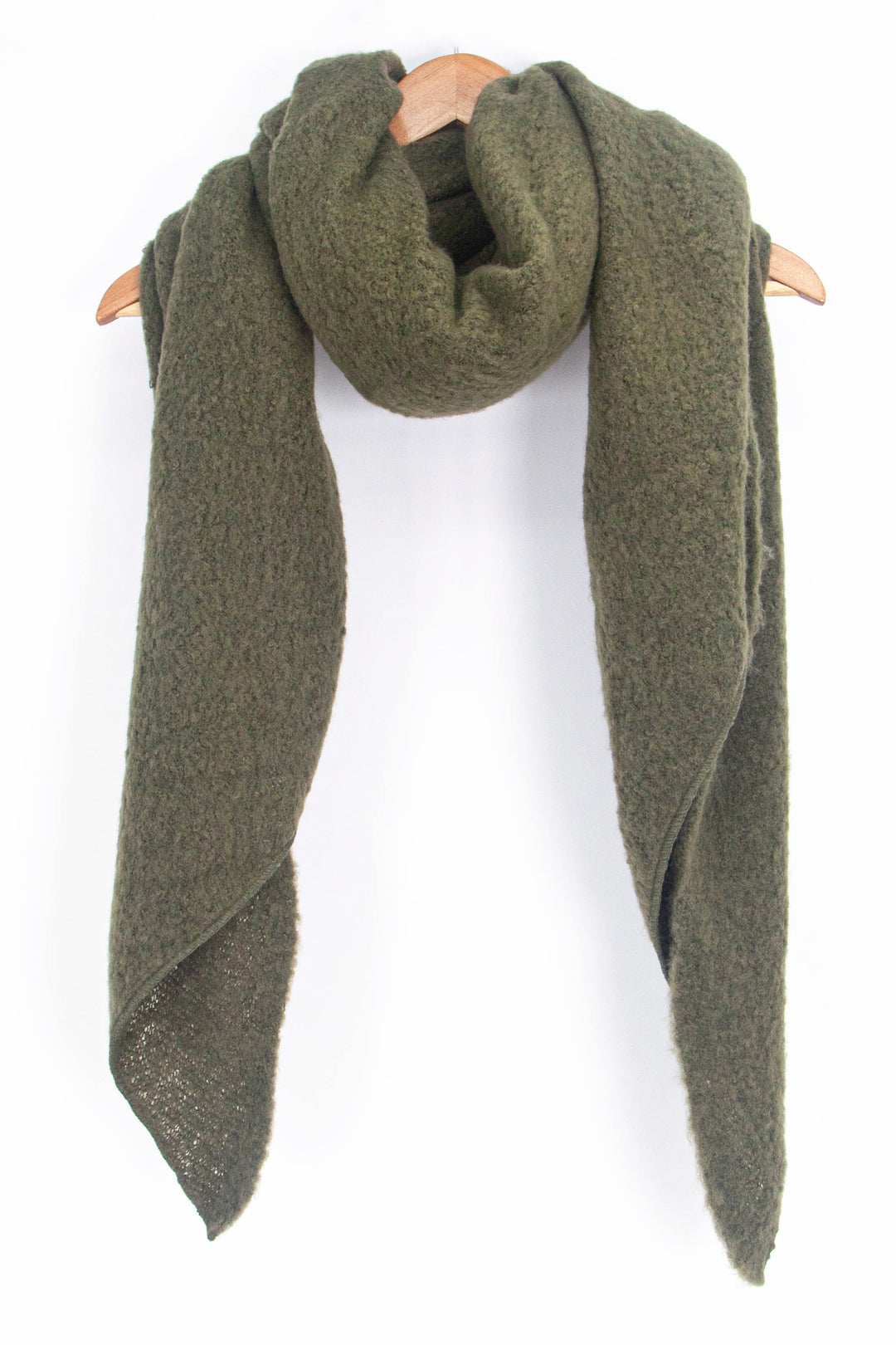 asymmetric khaki green winter scarf draped around a coat hanger