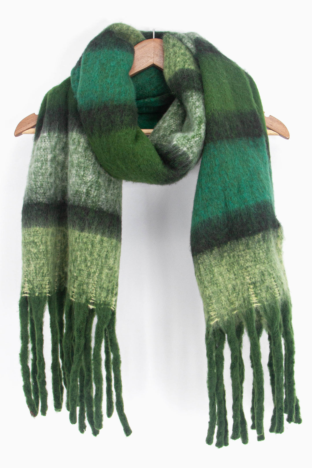 showing the green colour block striped winter scarf draped around a coat hanger