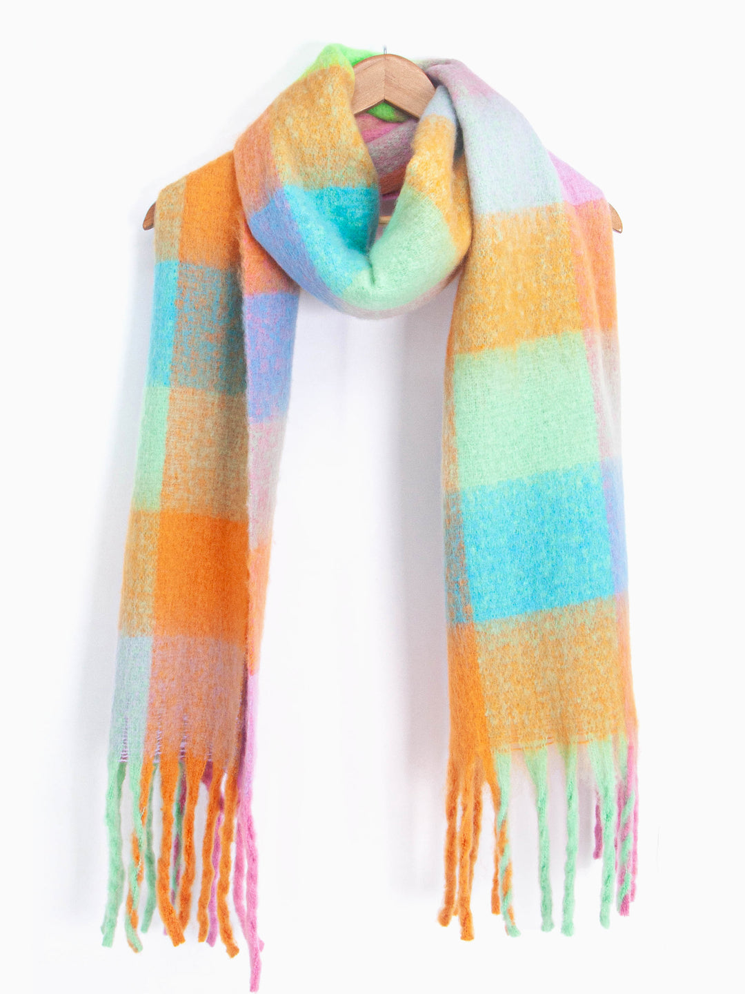 showing the multicoloured square colour block winter scarf draped around a coat hanger, showing how it would look when worn.