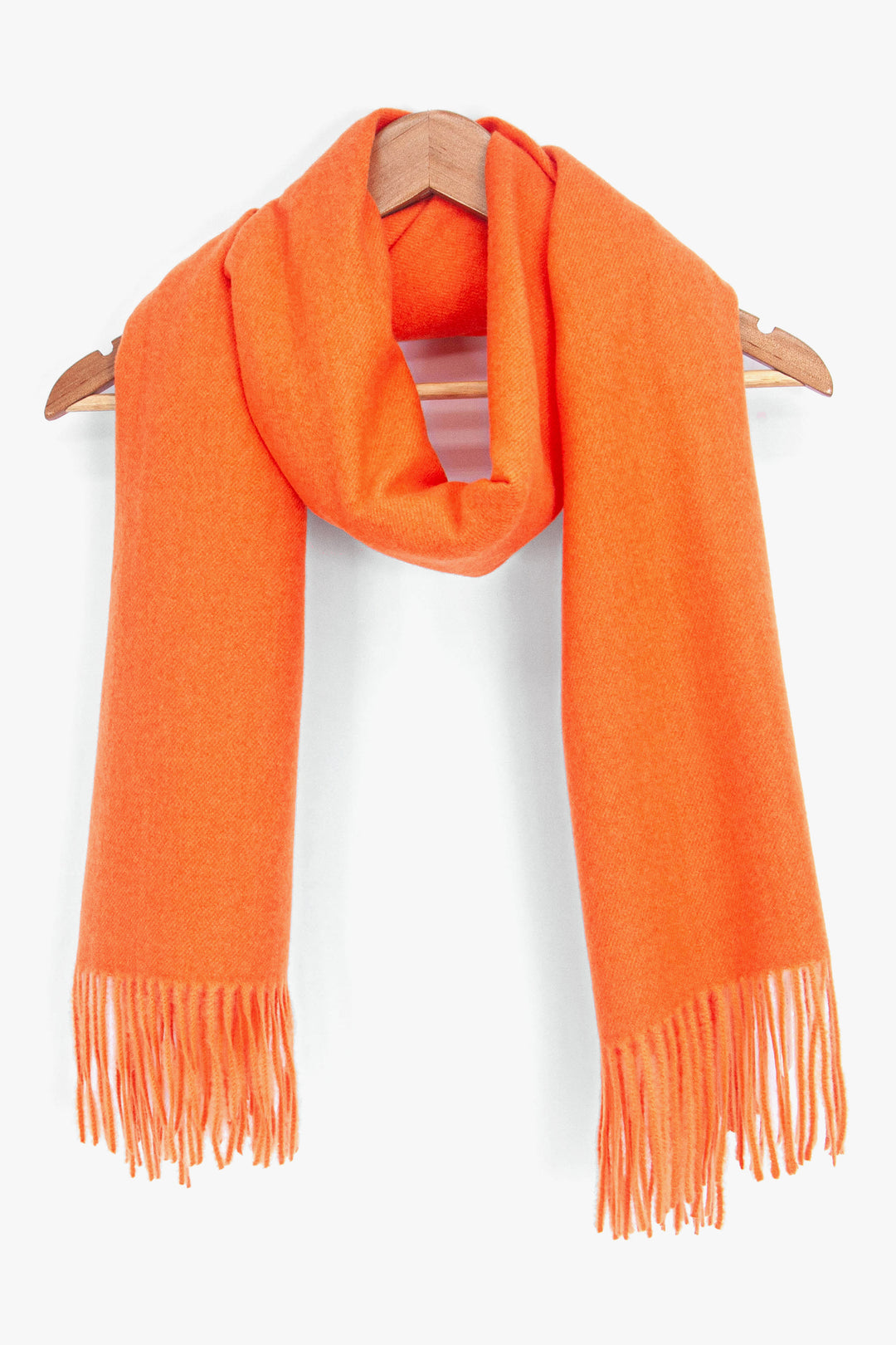 showing the orange winter scarf draped around a coat hanger