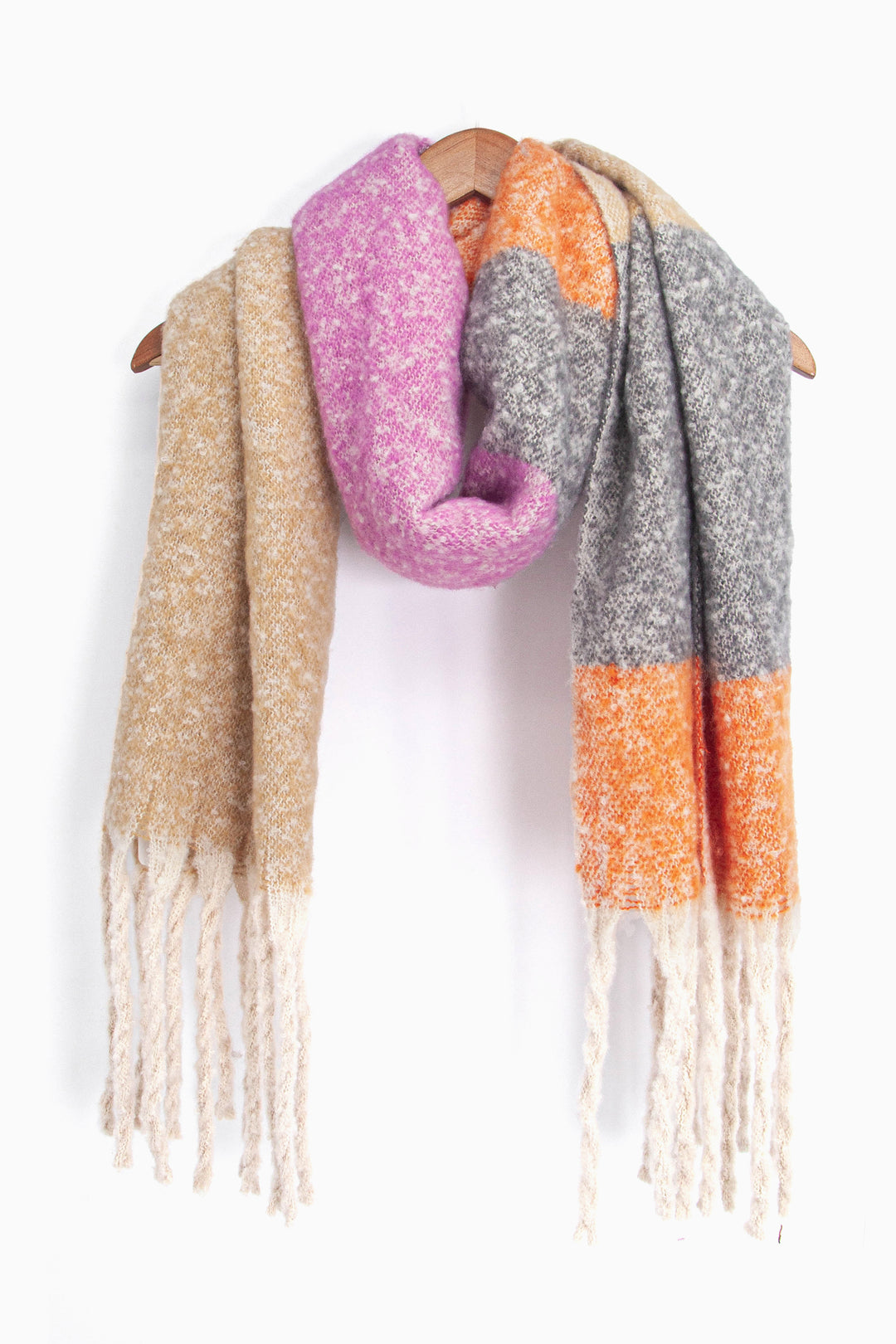 showing the grey, pink, orange and beige colour block winter scarf draped around a coat hanger, showing how it would look when worn.