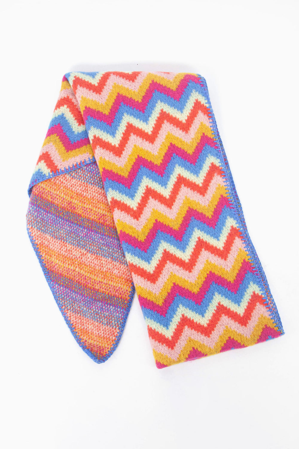 showing the scarf folded while laying flat, the multicoloured zig zag pattern is clearly highlighted.