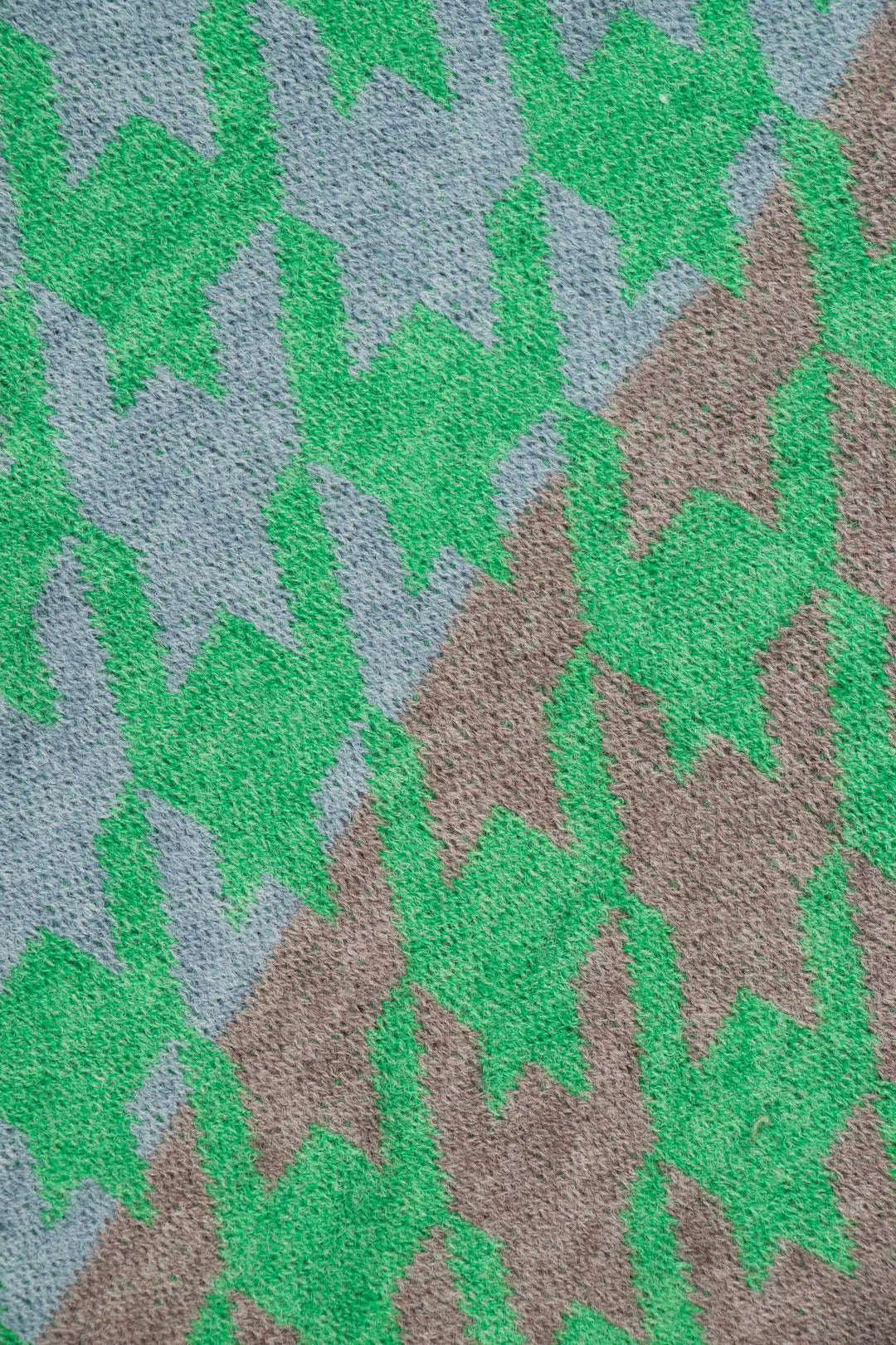 close up of the green, grey and blue houndstooth pattern on the scarf