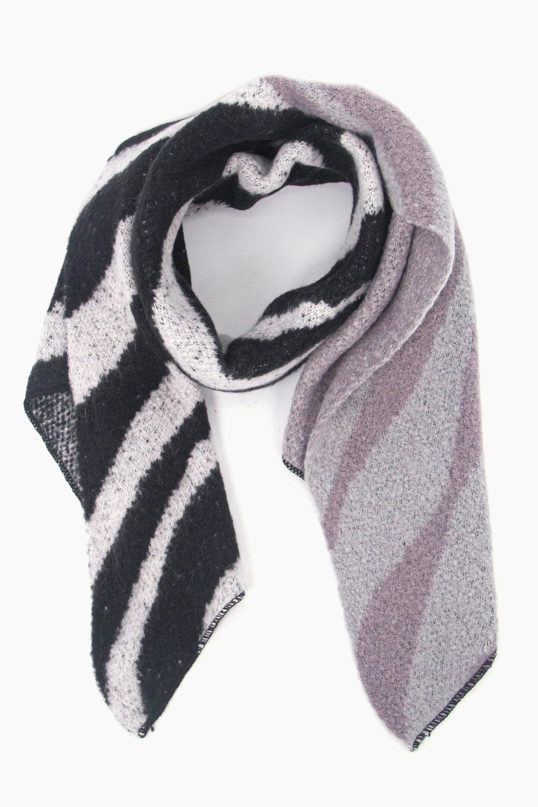 a winter blanket scarf with a pattern of animal print stripes, the scarf is grey ombre and ranges from black to light grey 