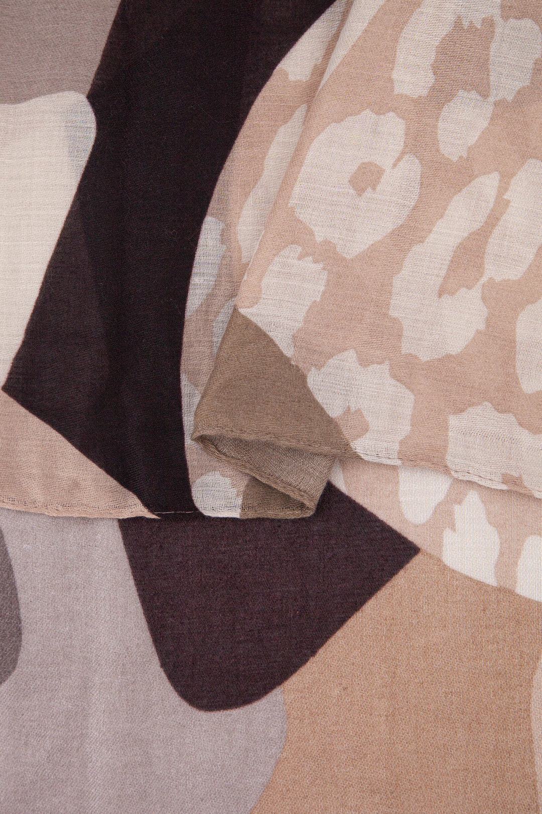 close up of the soft viscose fabric, the neutral tone colourways and leopard print pattern are clearly visible