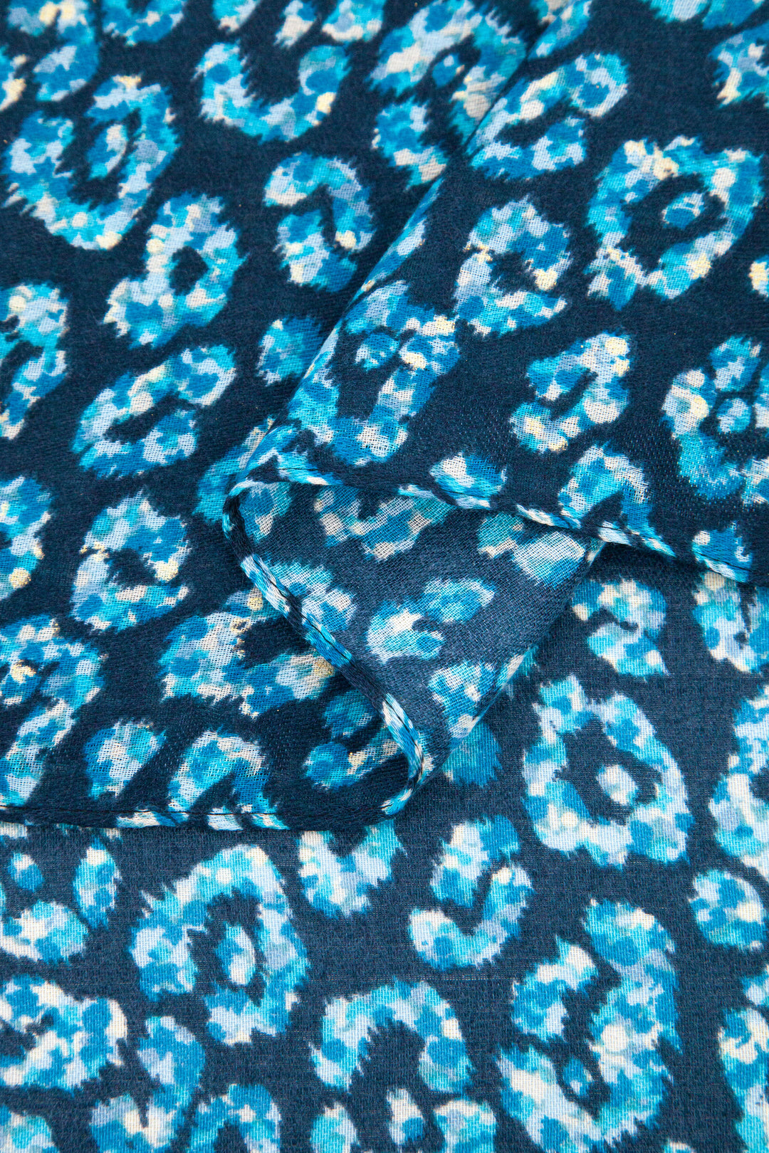 close up of the soft viscose fabric, the blue leopard print colourway is clearly visible