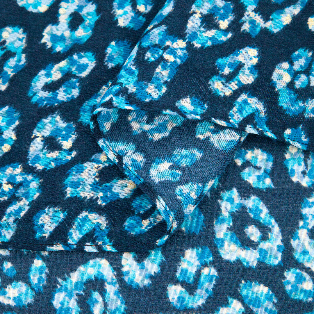 close up of the soft viscose fabric, the blue leopard print colourway is clearly visible