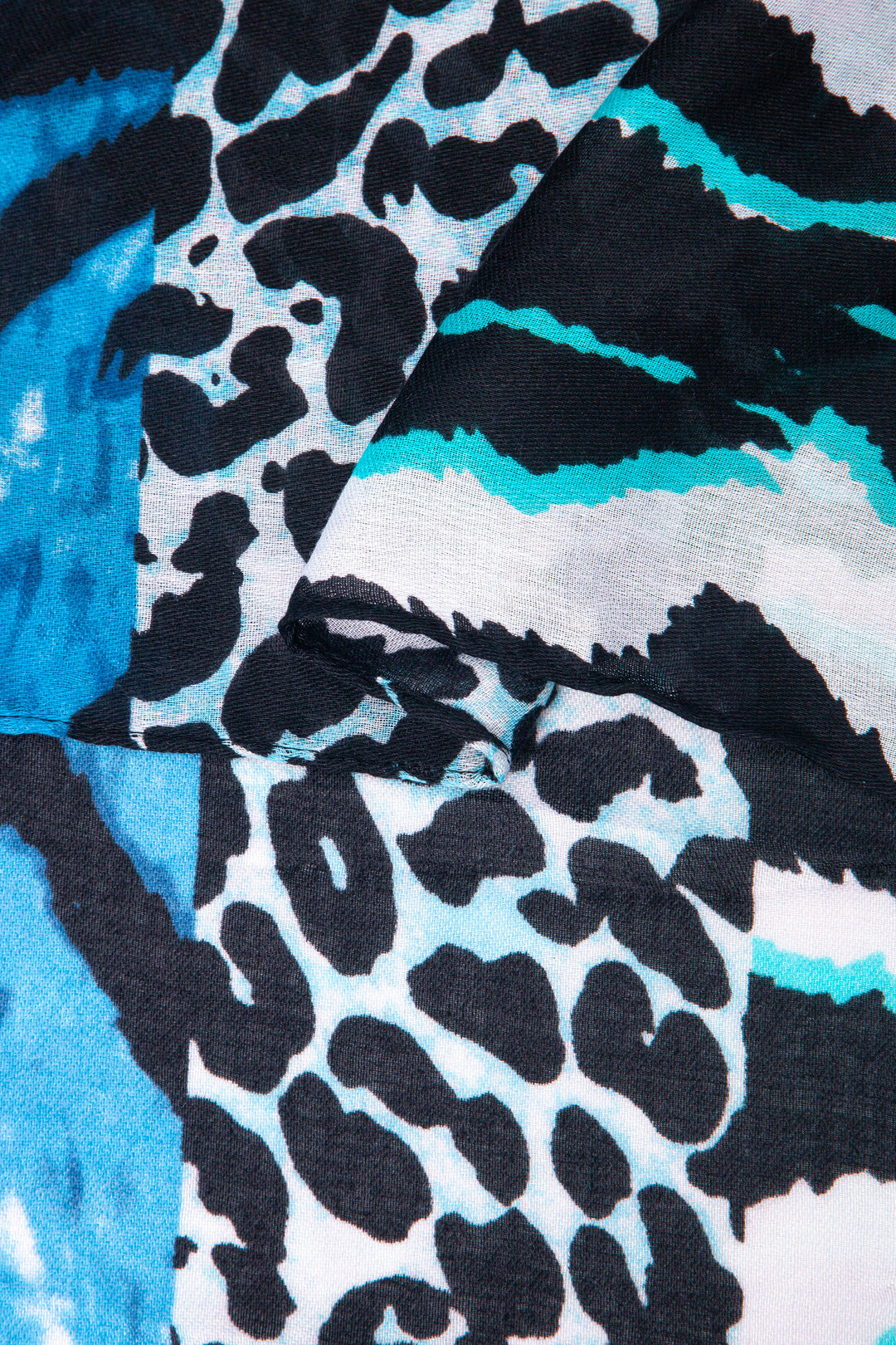 close up of the soft viscose fabric, the blue colourway and mixed leopard and zebra print patterns are clearly visible