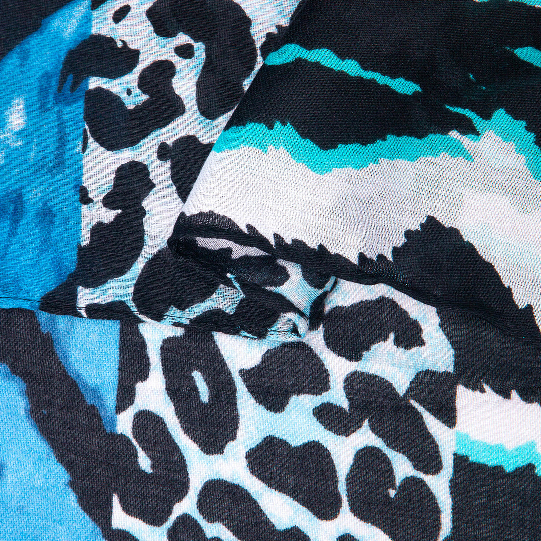 close up of the soft viscose fabric, the blue colourway and mixed leopard and zebra print patterns are clearly visible