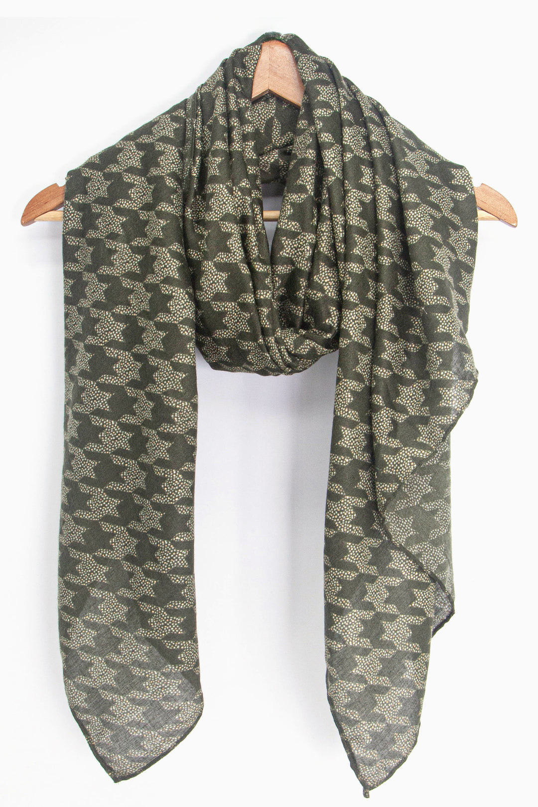 showing the scarf draped around a coat hanger, showing the all over pattern and how it would look when worn