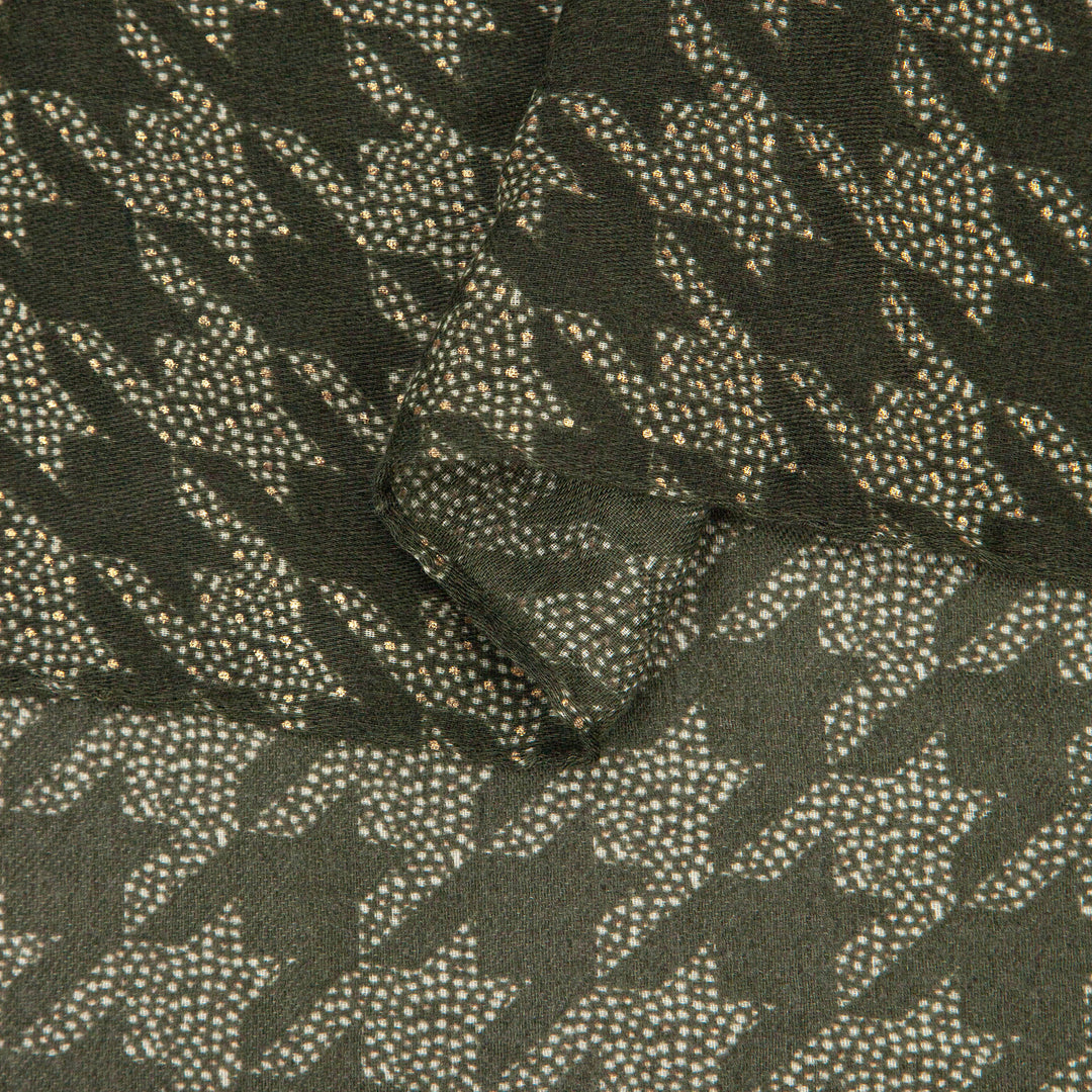 close up of the soft viscose fabric, the khaki green colourway and houndstooth pattern is clearly visible