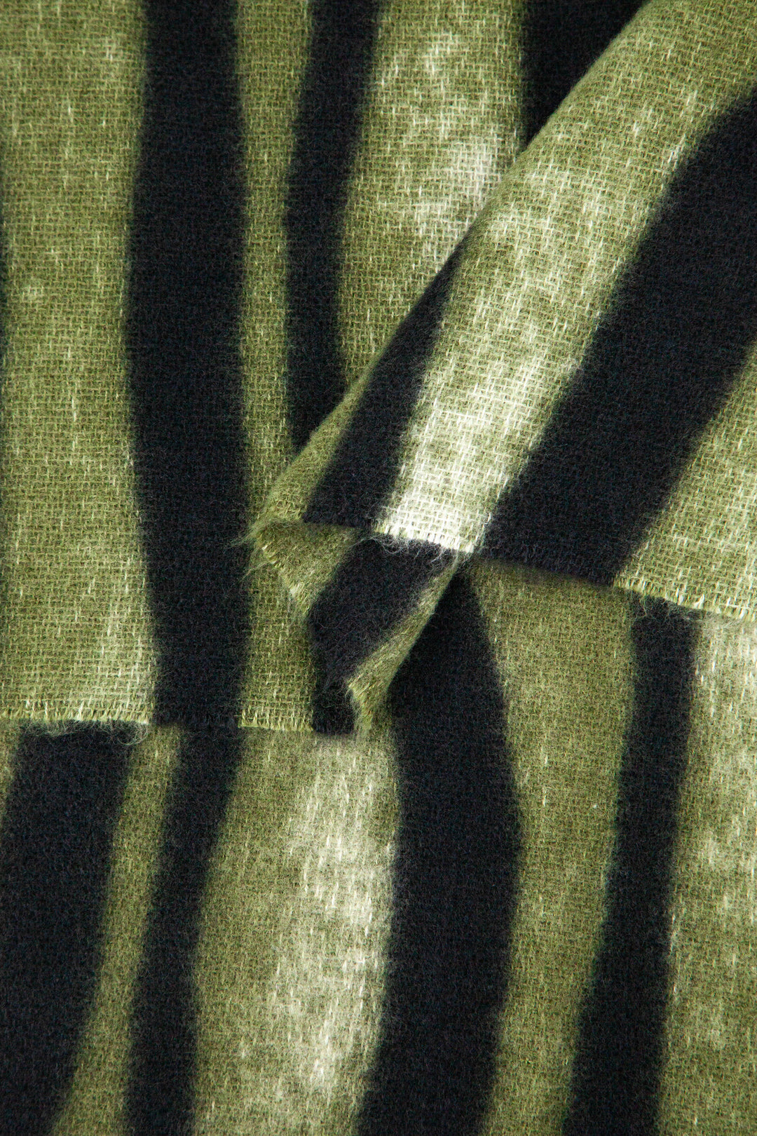 close up of the soft viscose fabric, the green and black colourways are clearly visible