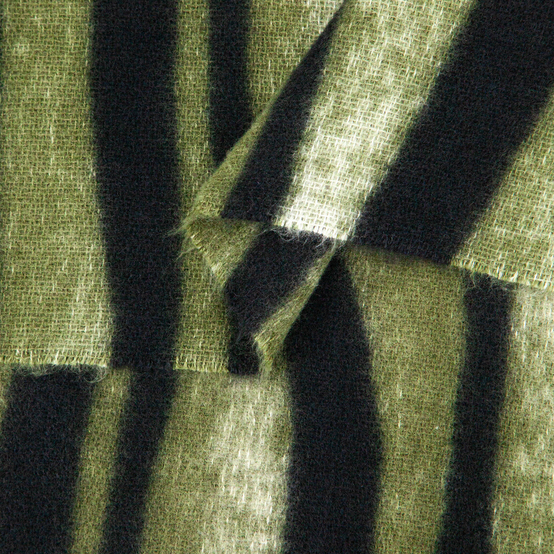 close up of the soft viscose fabric, the green and black colourways are clearly visible