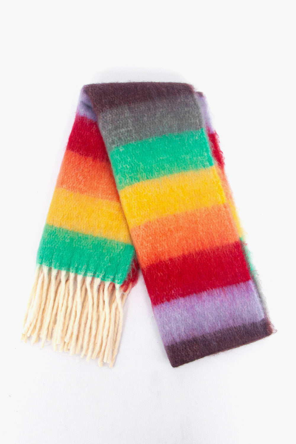 showing the scarf folded while laying flat, the multicoloured rainbow striped pattern is highlighted as is the cream tassel fringe