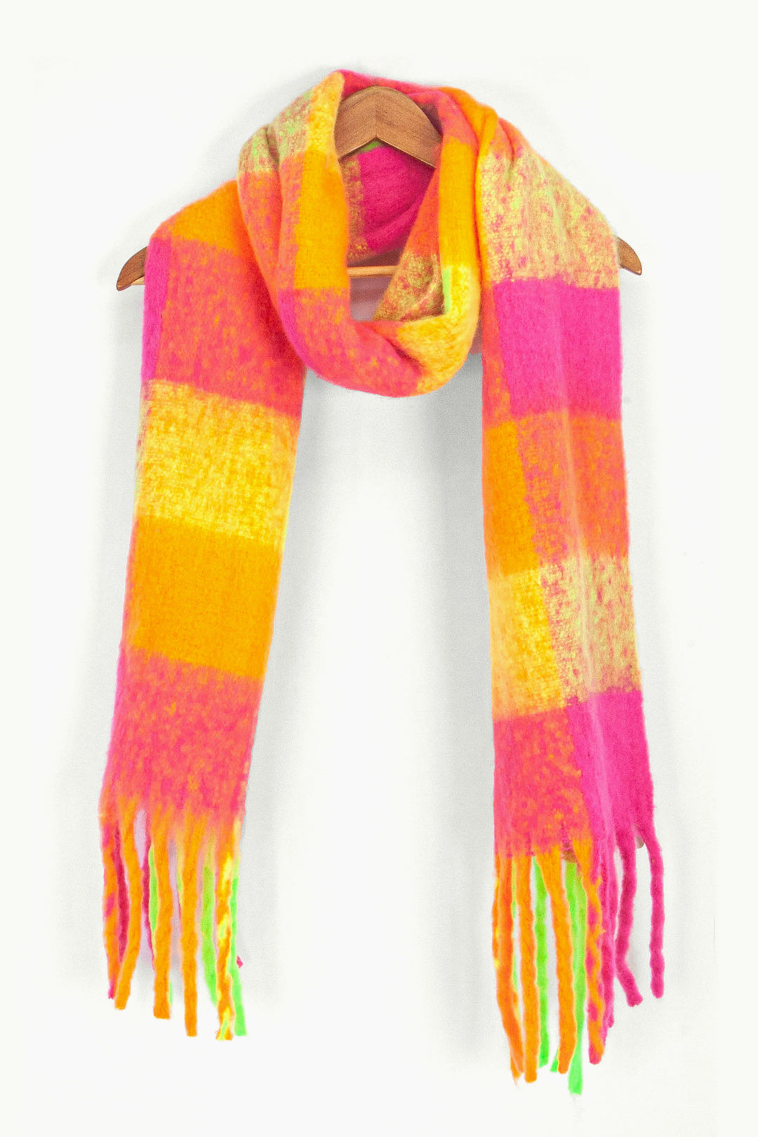 showing the pink, orange and yellow check colour block winter scarf draped around a coat hanger, showing how it would look when worn.