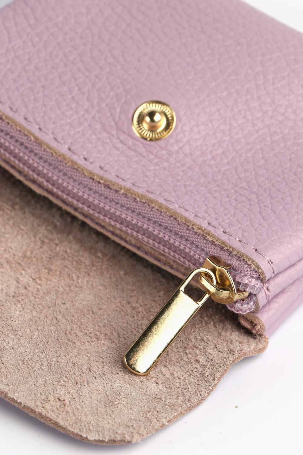 showing the internal zip closure compartment of this small lilac coin purse