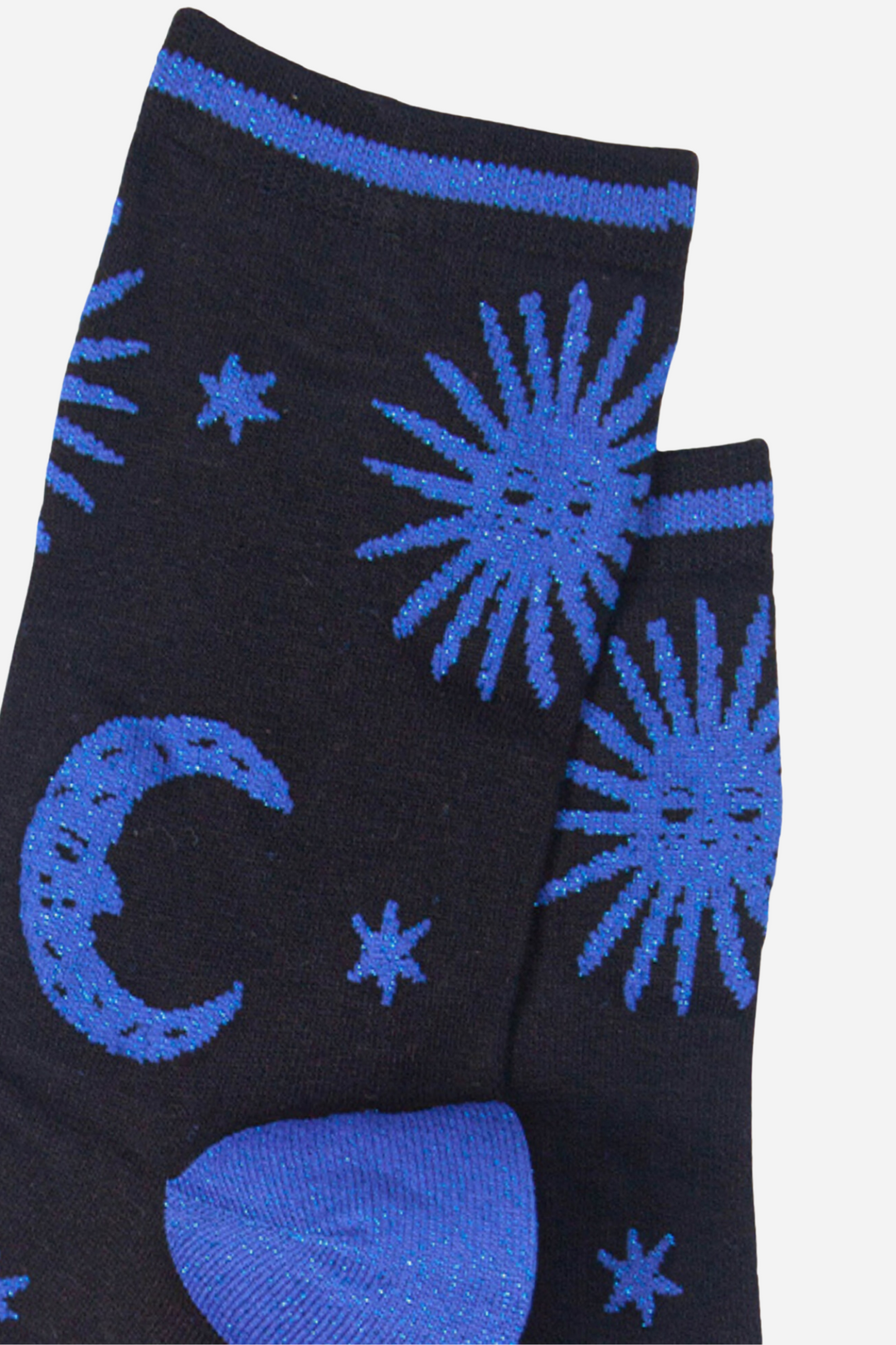 close up of the blue glitter sun and moon pattern on the black bamboo socks