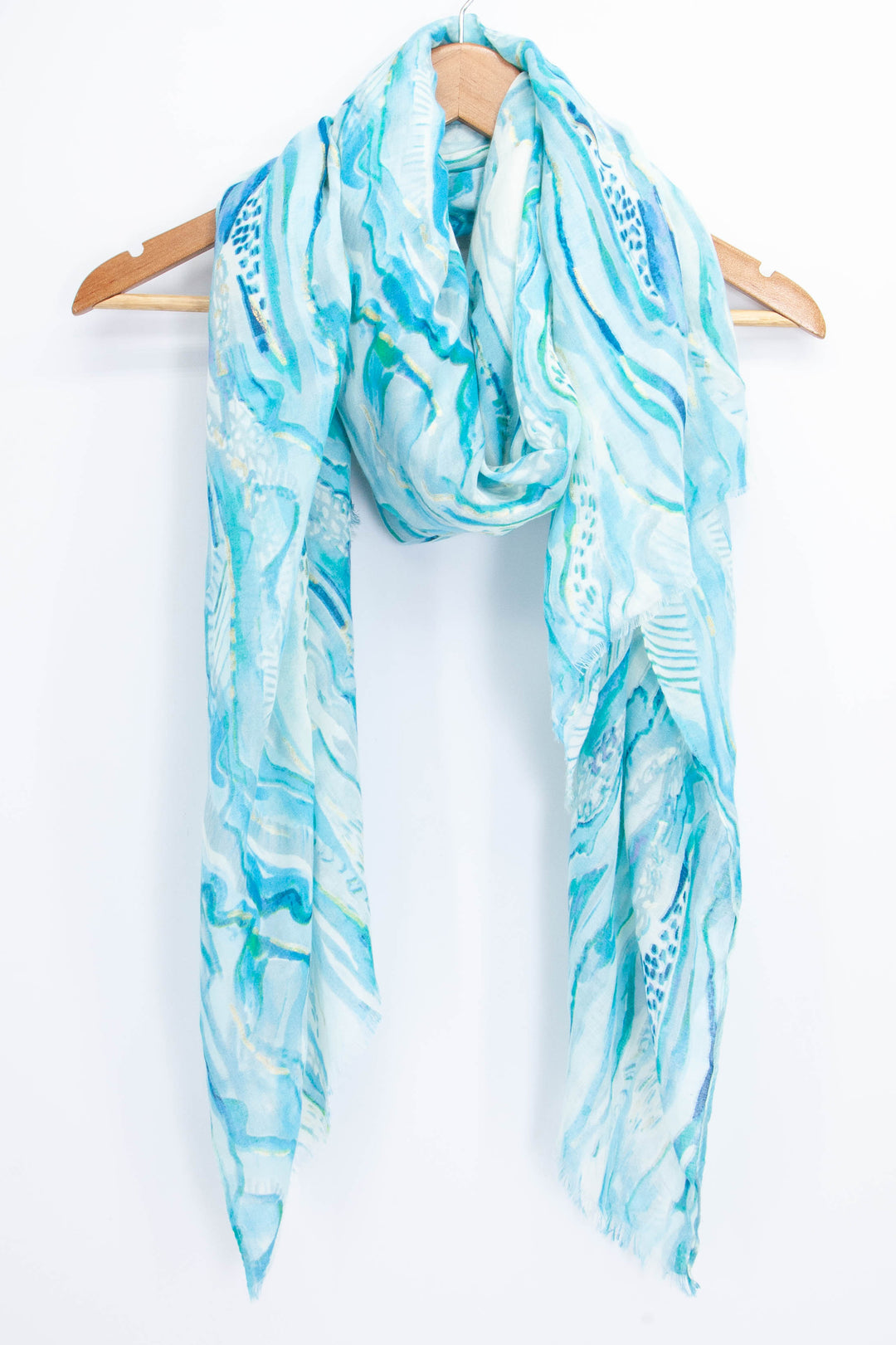 light blue wave pattern scarf with gold foil accents draped around a coat hanger