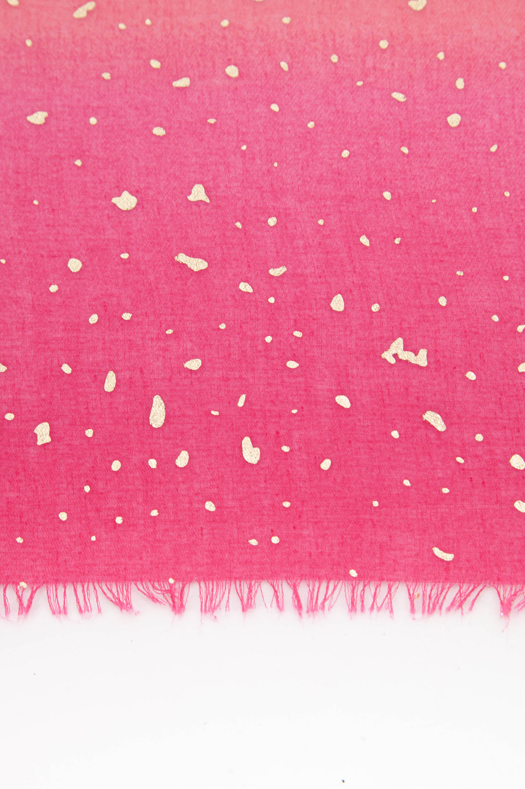 close up of the scattered gold foil pattern on the pink ombre scarf