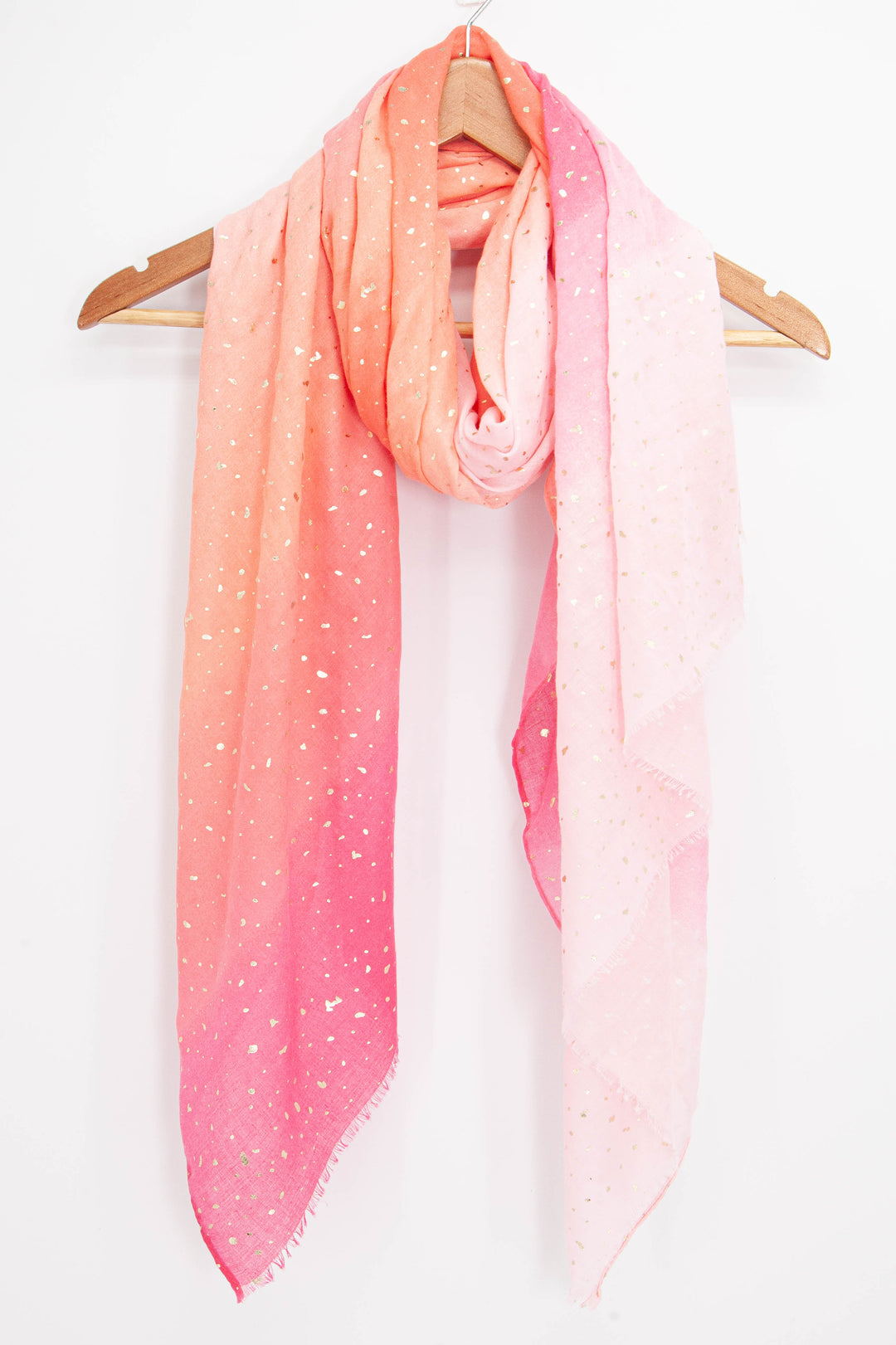pink ombre foil scarf draped around a coat hanger