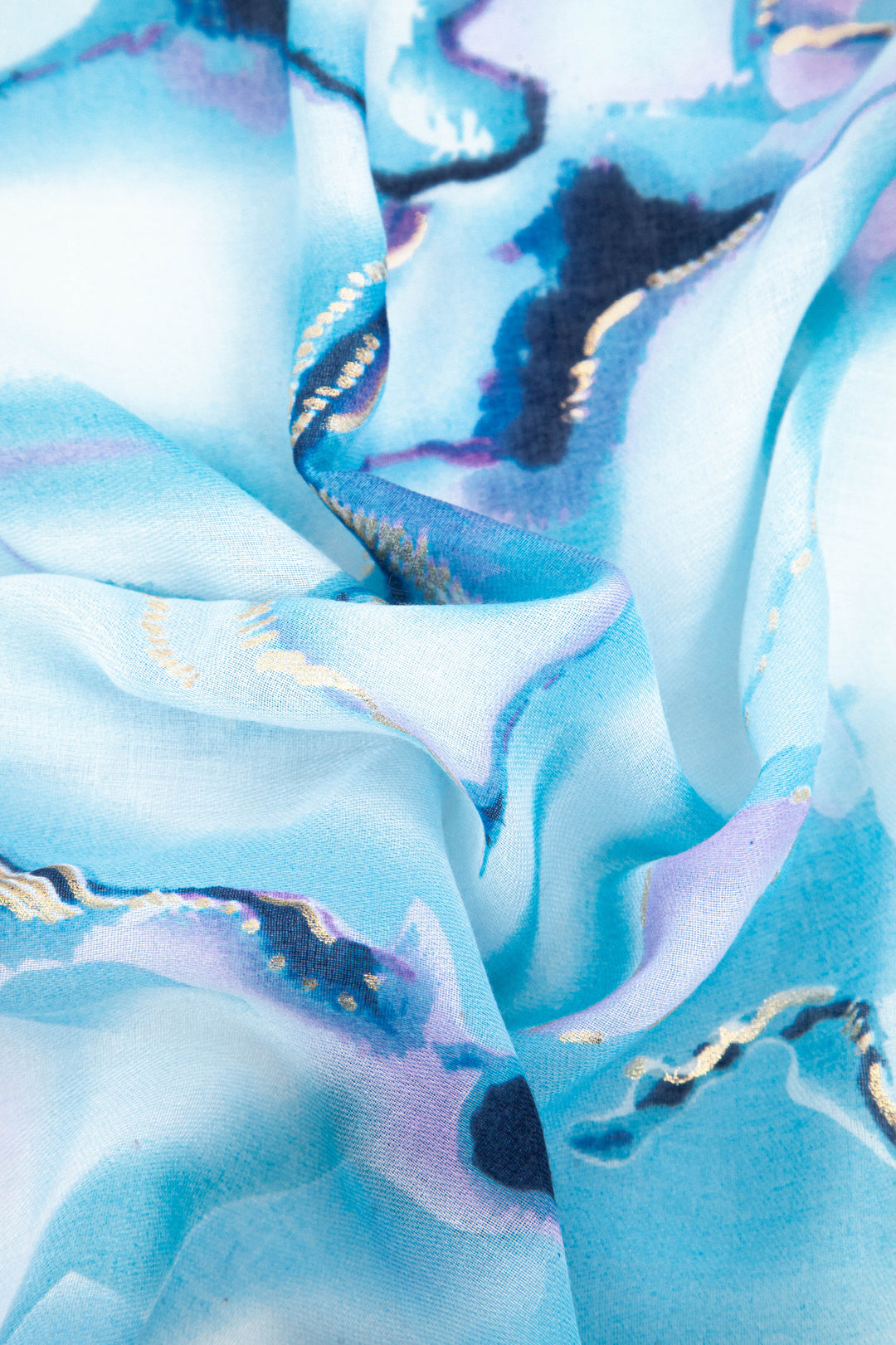 close up of the blue tie dye pattern and lightweight material of this summer scarf