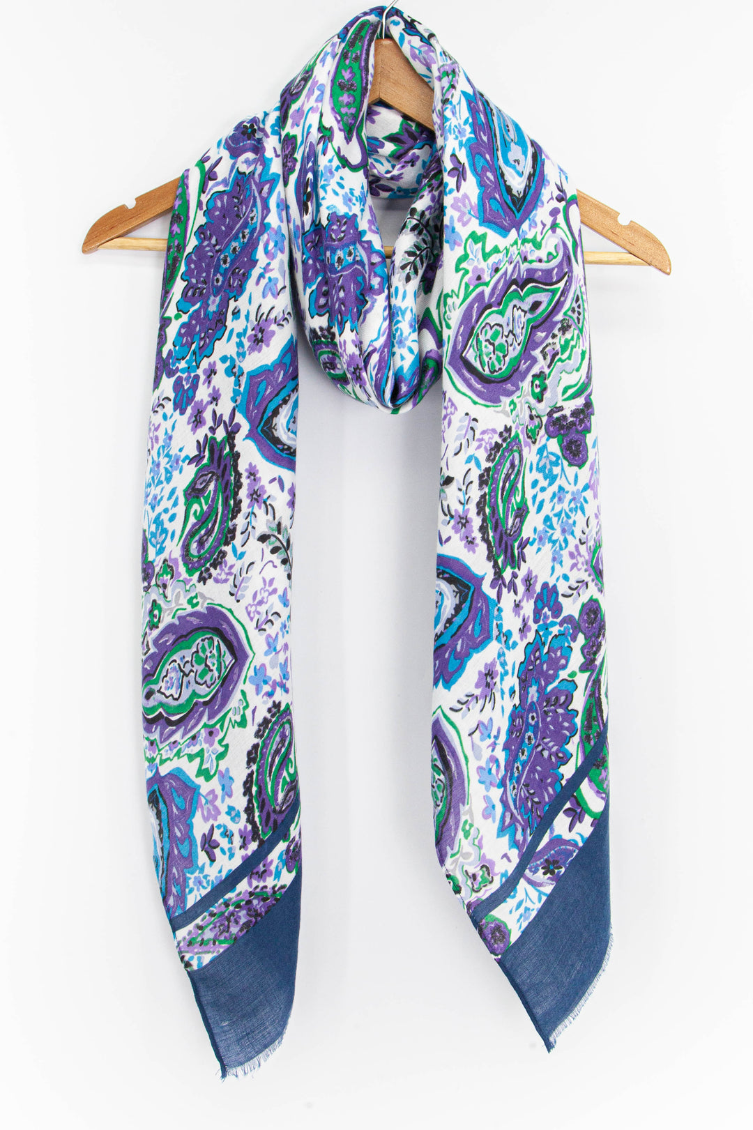 blue paisley print scarf draped around a coat hanger showing the blue, purple and green pattern