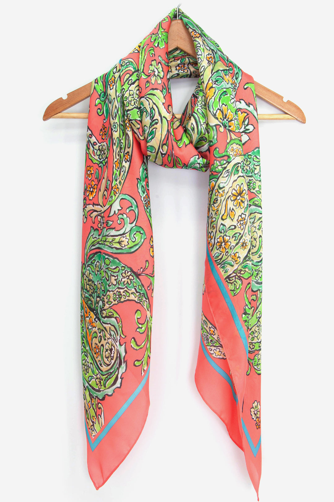 coral paisley pattern scarf wrapped around a coat hanger, showing the ornate paisley floral design on this silky scarf