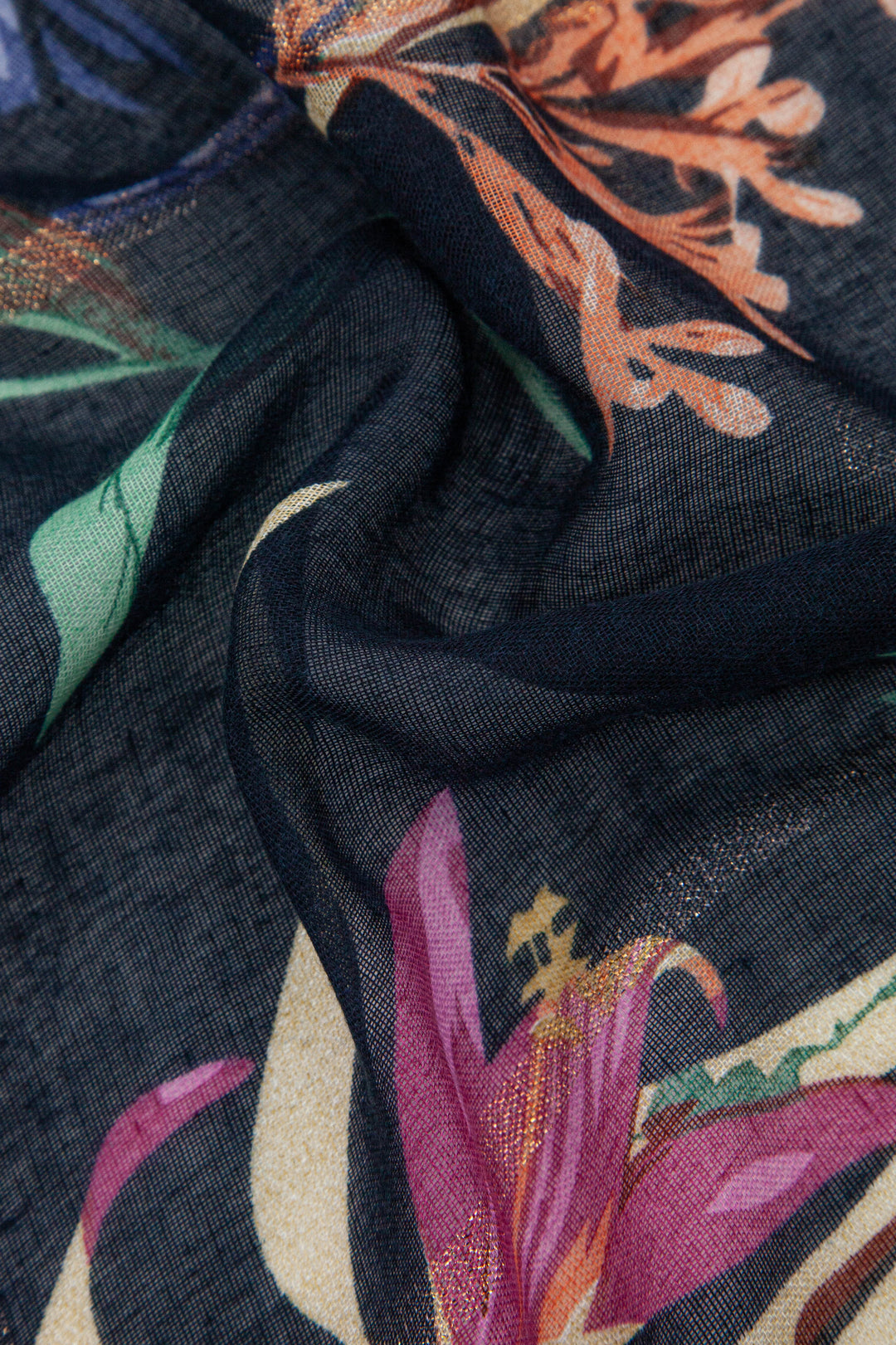 close up of the gold glitter stripe and floral pattern on the scarf