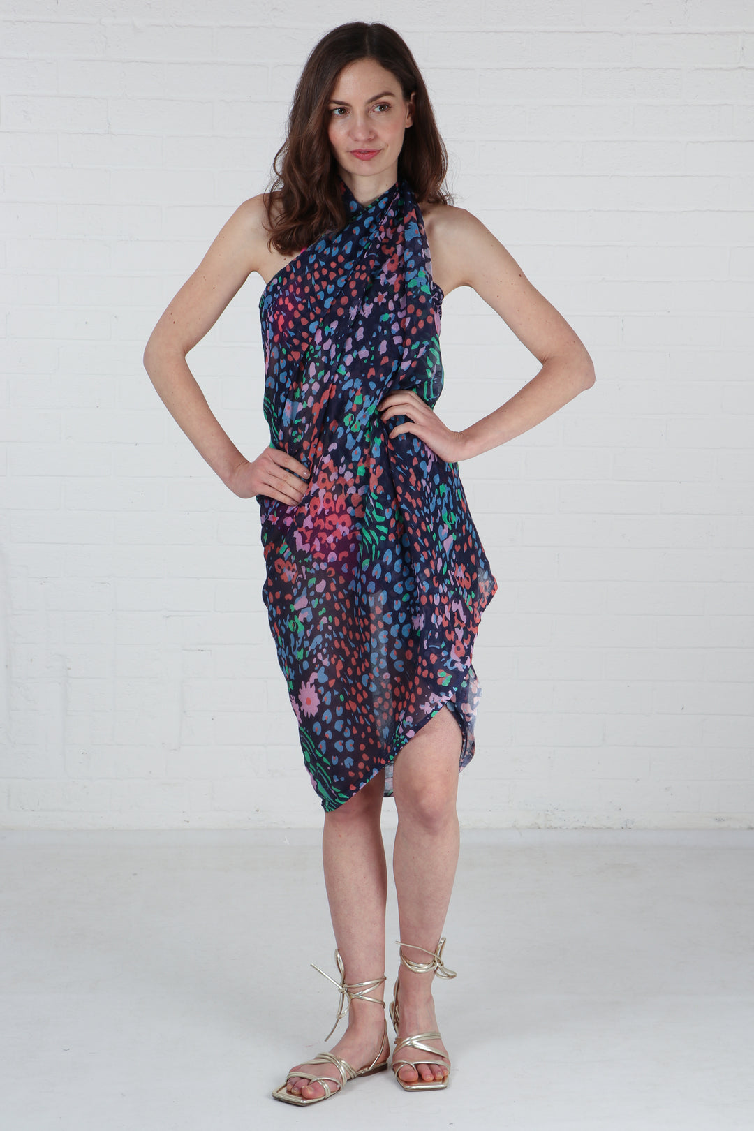 model wearing a navy blue floral print scarf as a beach cover up dress