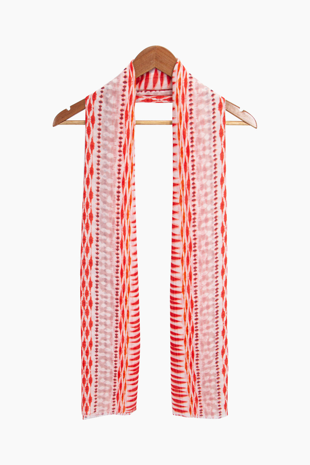 madeline-lightweight-scarf-red-boho-geometric-draped-around-a-coat-hanger