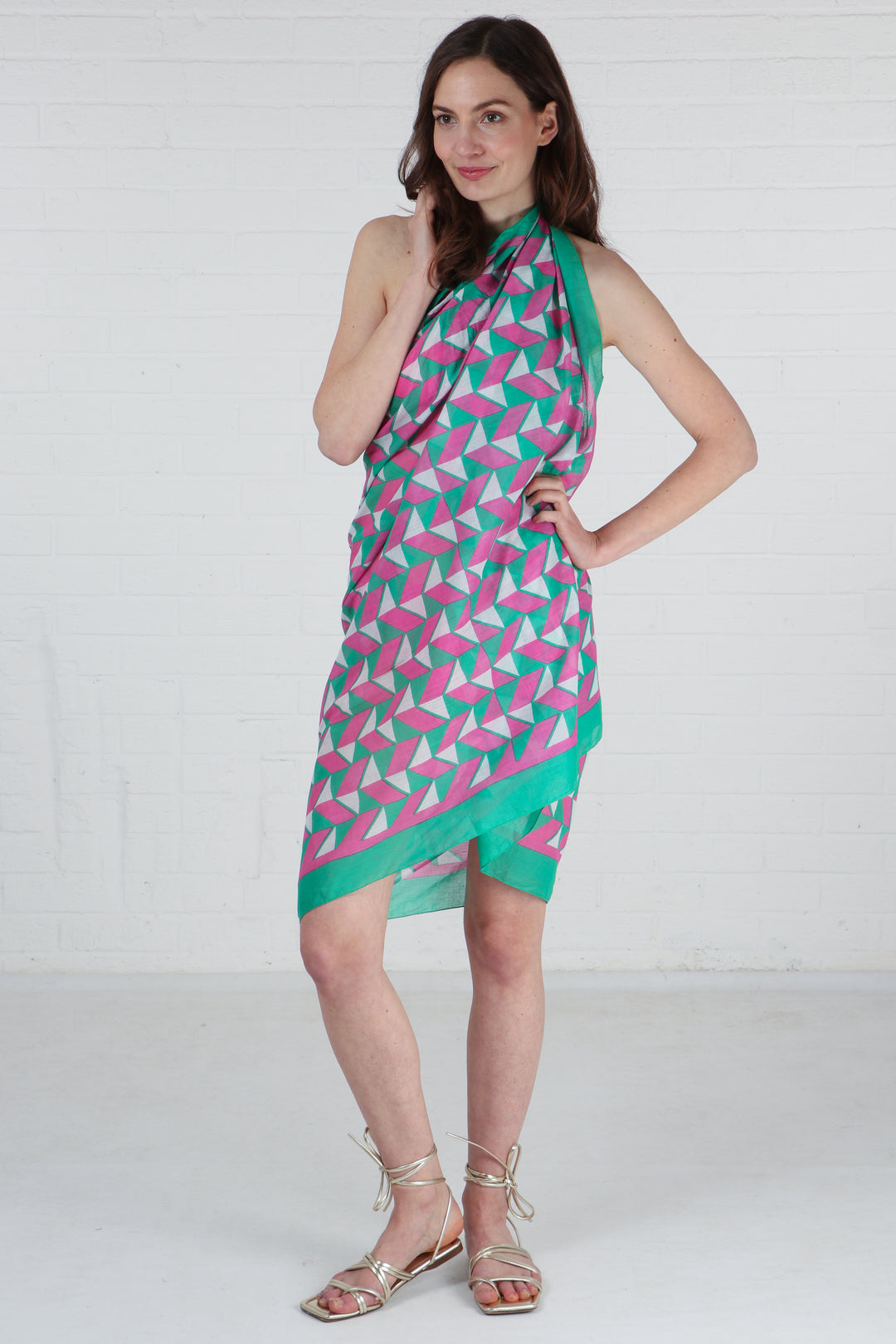 model wearing a green bordered geometric print scarf as a beach coverup dress