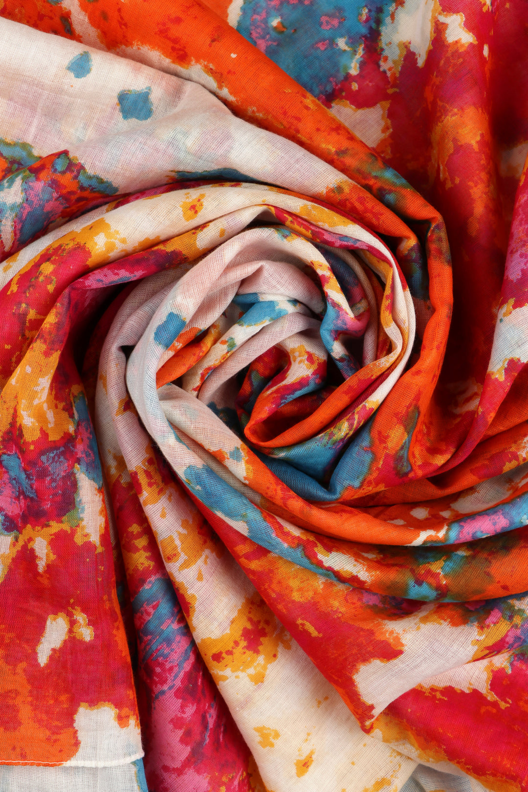 close up of the lightweight material and vibrant orange and pink tie die pattern