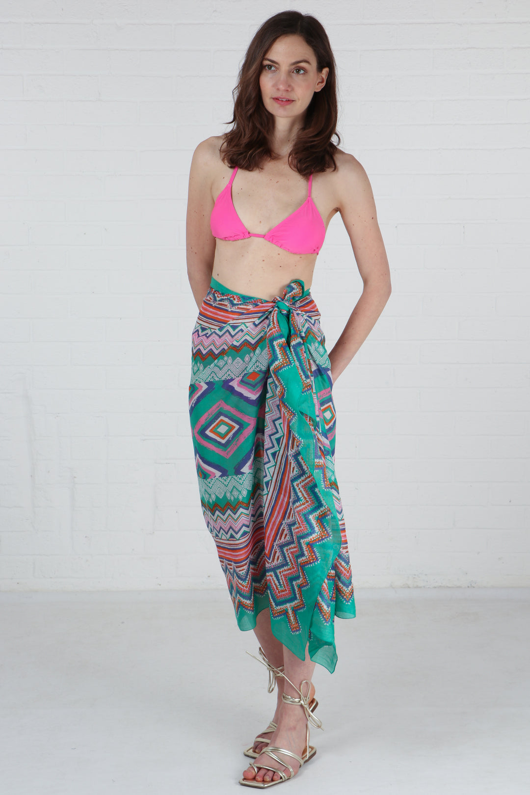 model wearing a green geometric print scarf as a beach cover up sarong