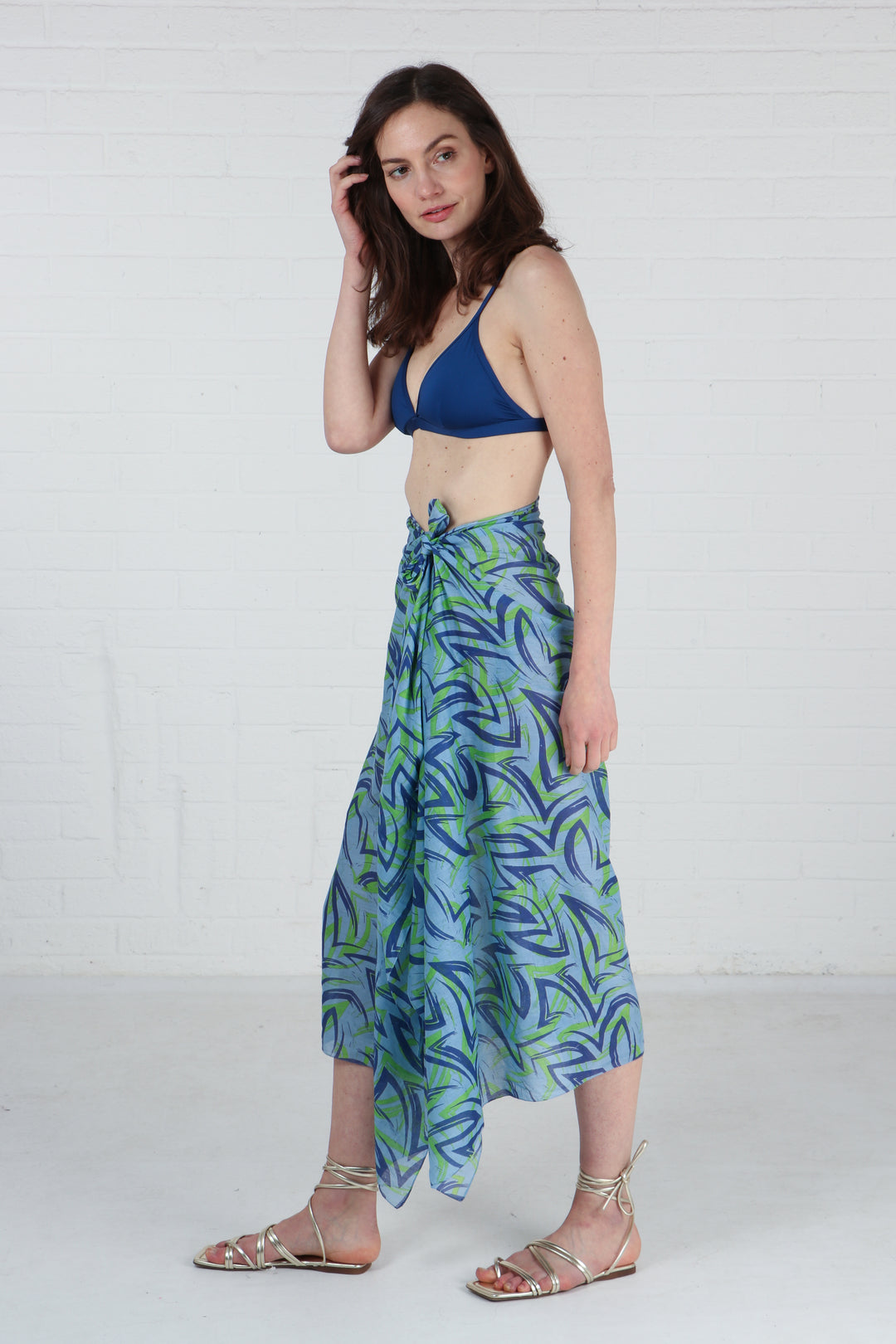 blue and green brushstroke pattern scarf being worn as a beach coverup sarong