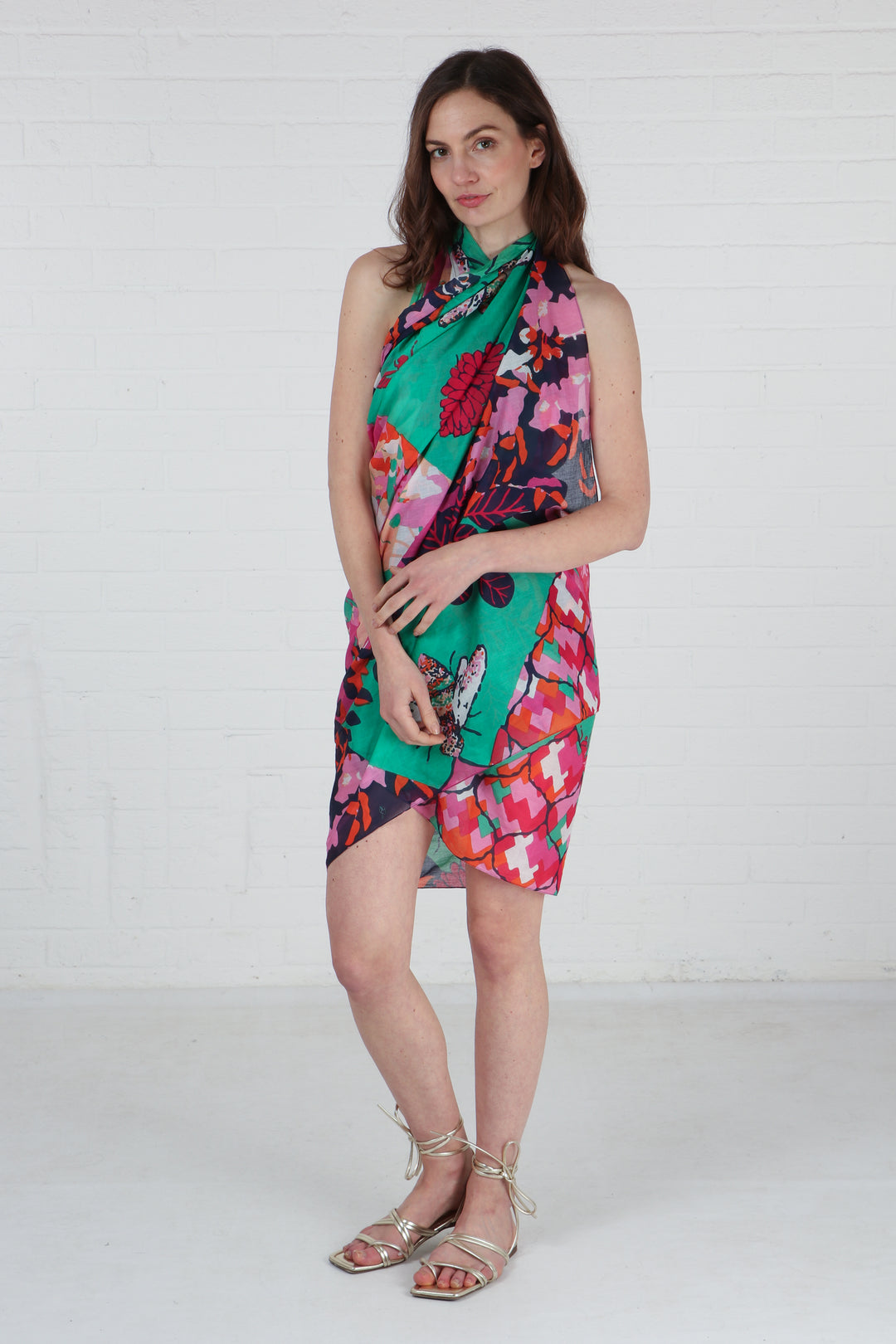 model wearing this cotton scarf as a beach cover up dress, showing the large bee print pattern and floral design