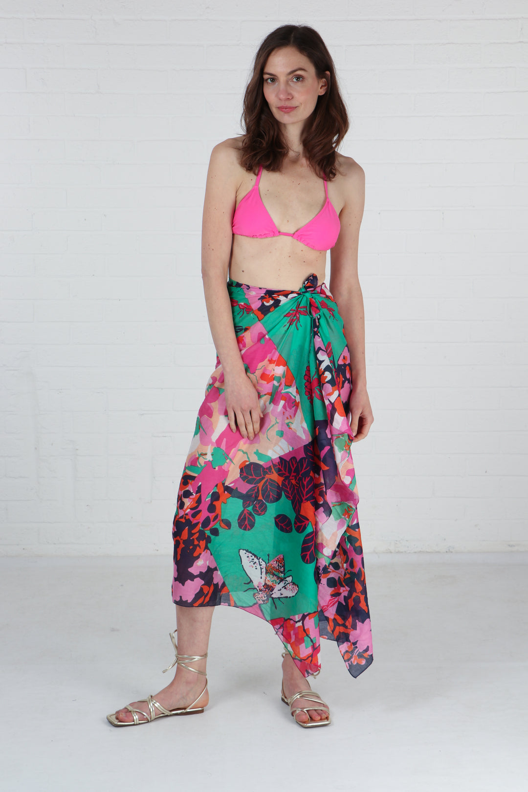 model wearing this green and pink cotton scarf as a beach coverup wrap